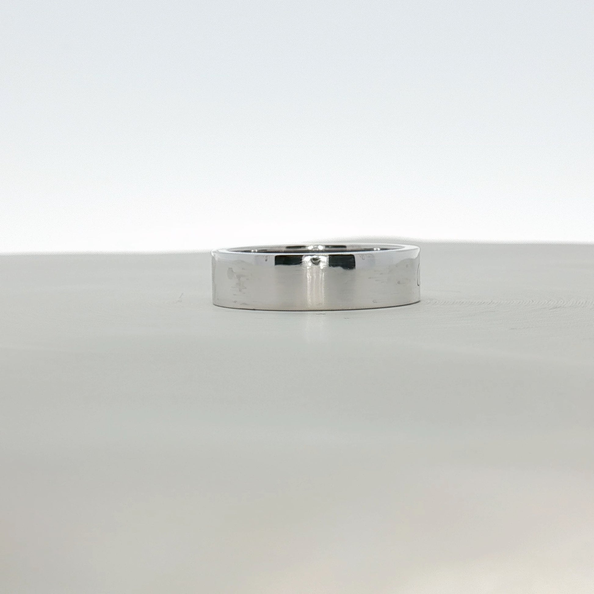 Cartier platinum wedding band ring featuring a sleek, polished design, showcased on a plain background.