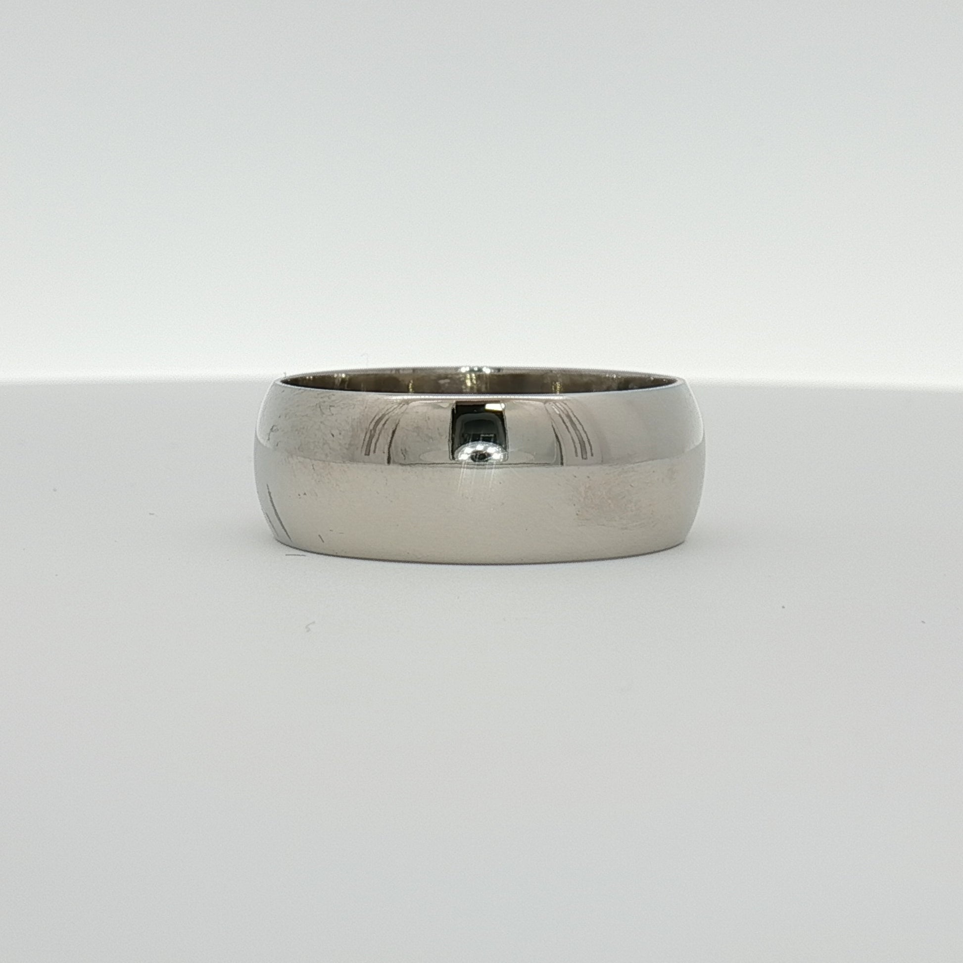Gold & Beyond gentleman’s wedding band in polished gold, featuring a sleek, classic design suitable for wedding jewelry.