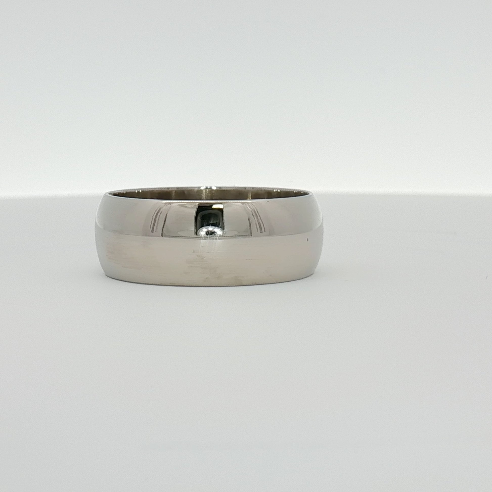 Gold & Beyond gentleman’s wedding band jewelry with a sleek, polished gold finish and classic design.