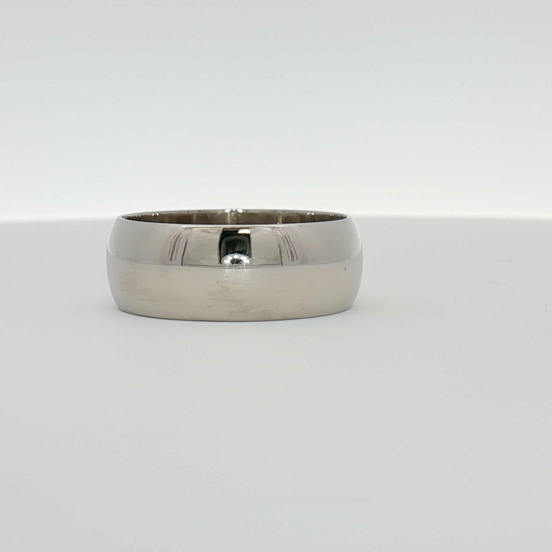 Gold & Beyond gentleman’s wedding band jewelry with a sleek, polished gold finish and classic design.