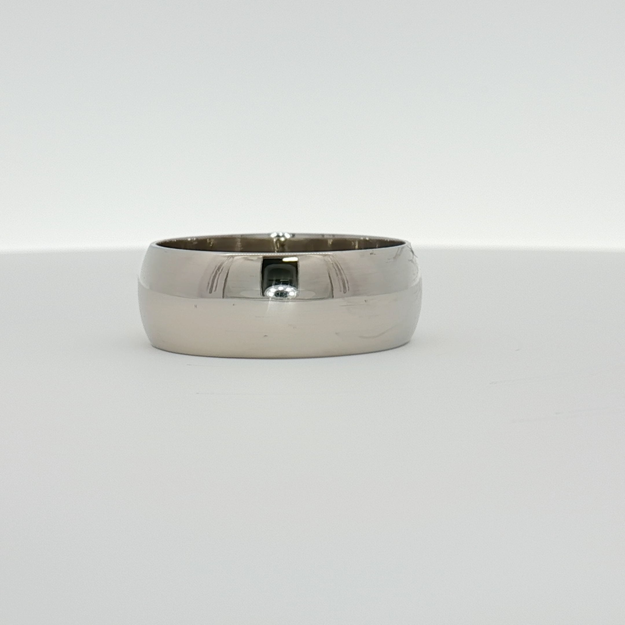Gold & Beyond gentleman's wedding band, sleek gold jewelry with a polished finish, designed for men's wedding or special occasion wear.