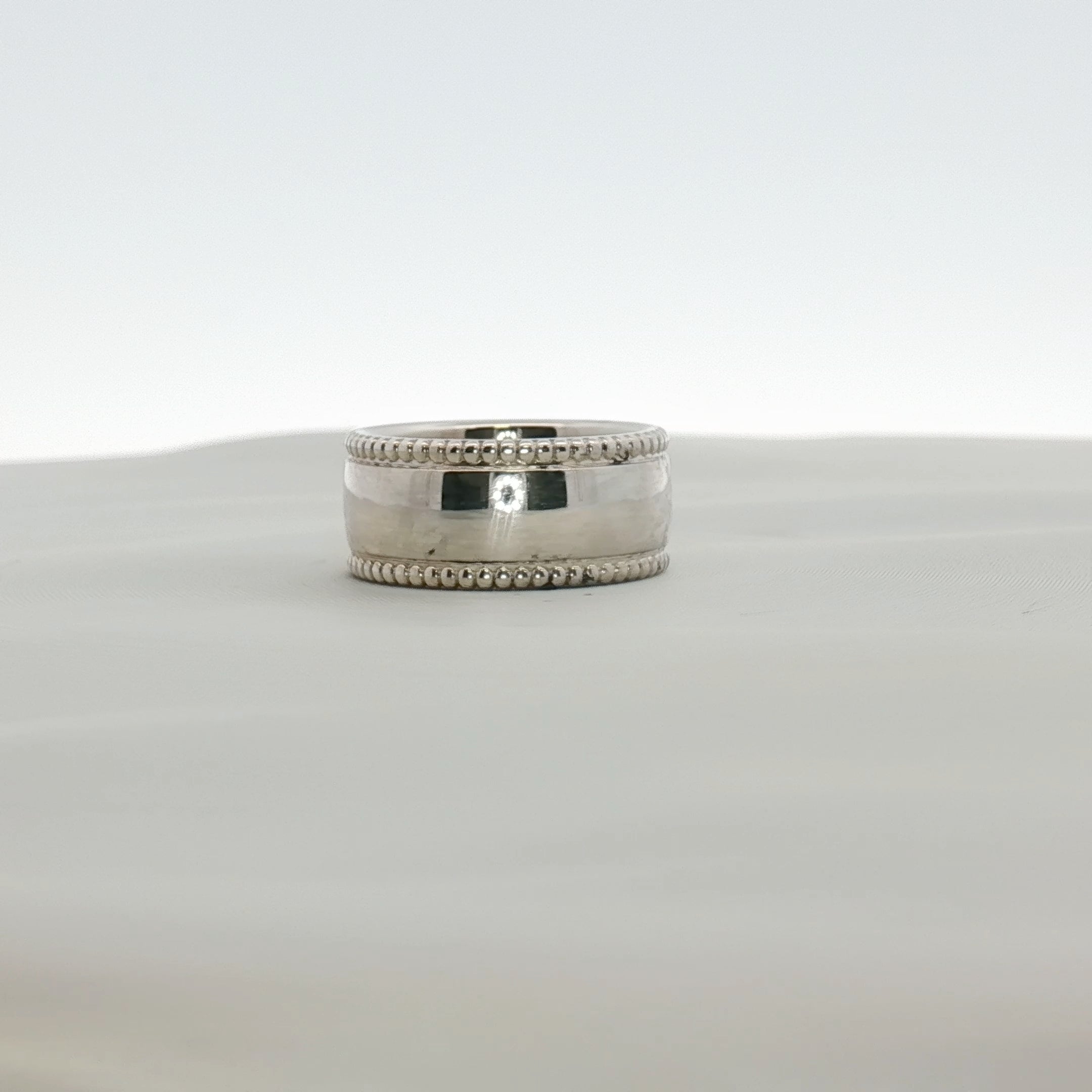 Sterling silver Tiffany & Co. Milgrain Band jewelry with intricate textured detailing, showcasing fine craftsmanship.