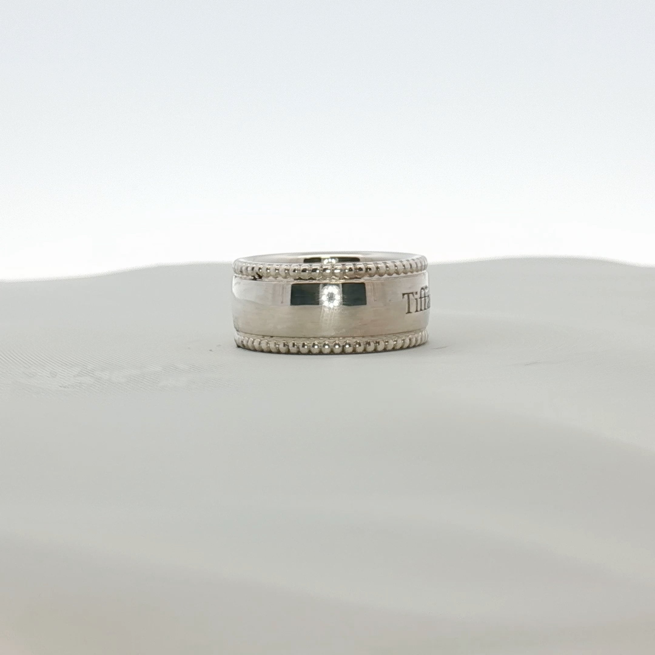 Sterling silver Tiffany & Co. Milgrain Band jewelry with detailed textured edge, crafted by Gold & Beyond.