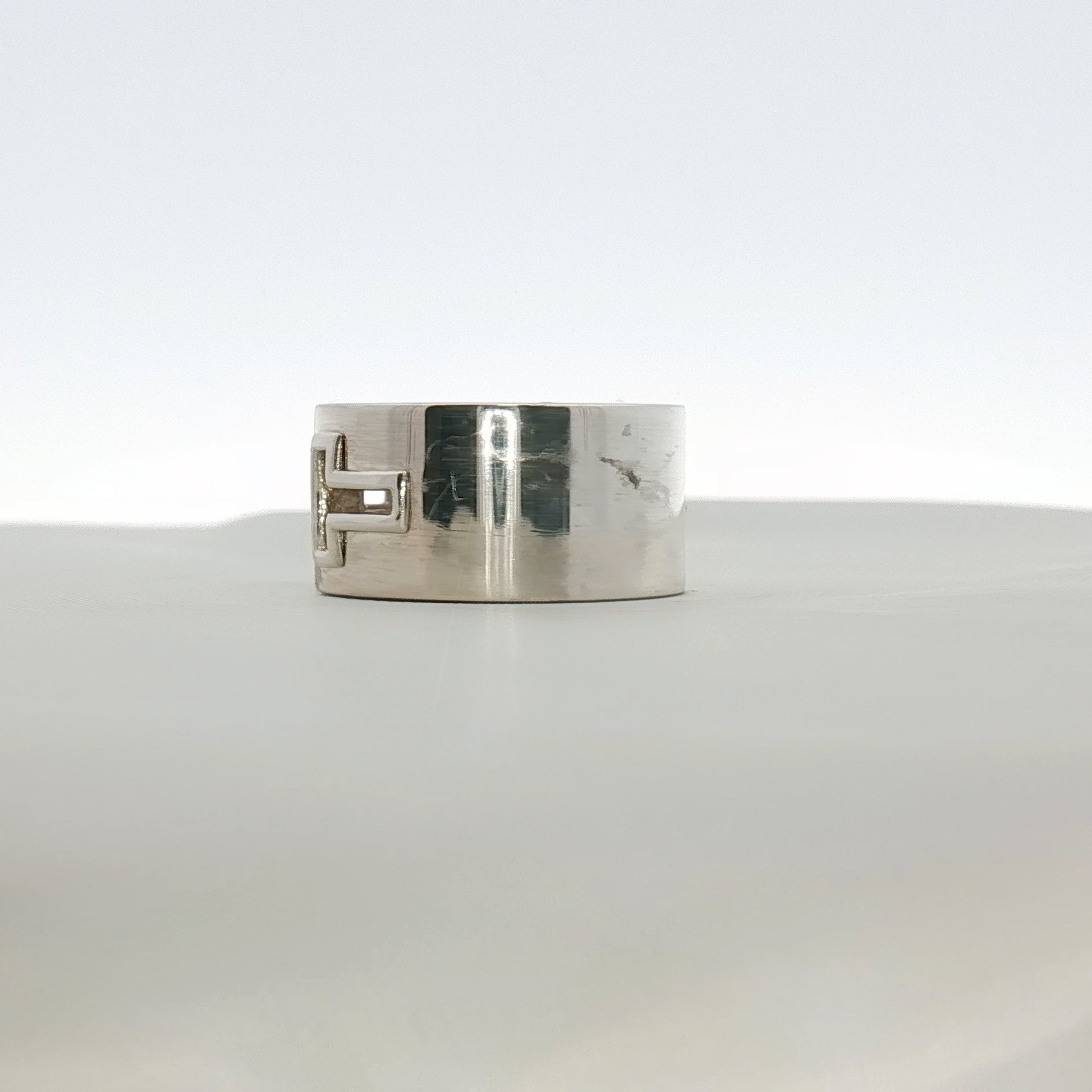 Gold & Beyond Tiffany & Co. T Wide Ring, a sleek gold jewelry piece with a T-shaped design, styled on a white background.
