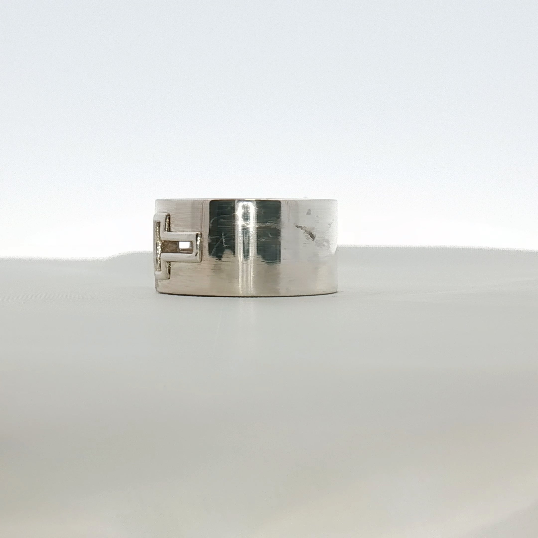 Gold & Beyond Tiffany & Co. T Wide Ring, a sleek gold jewelry piece with a T-shaped design, styled on a white background.