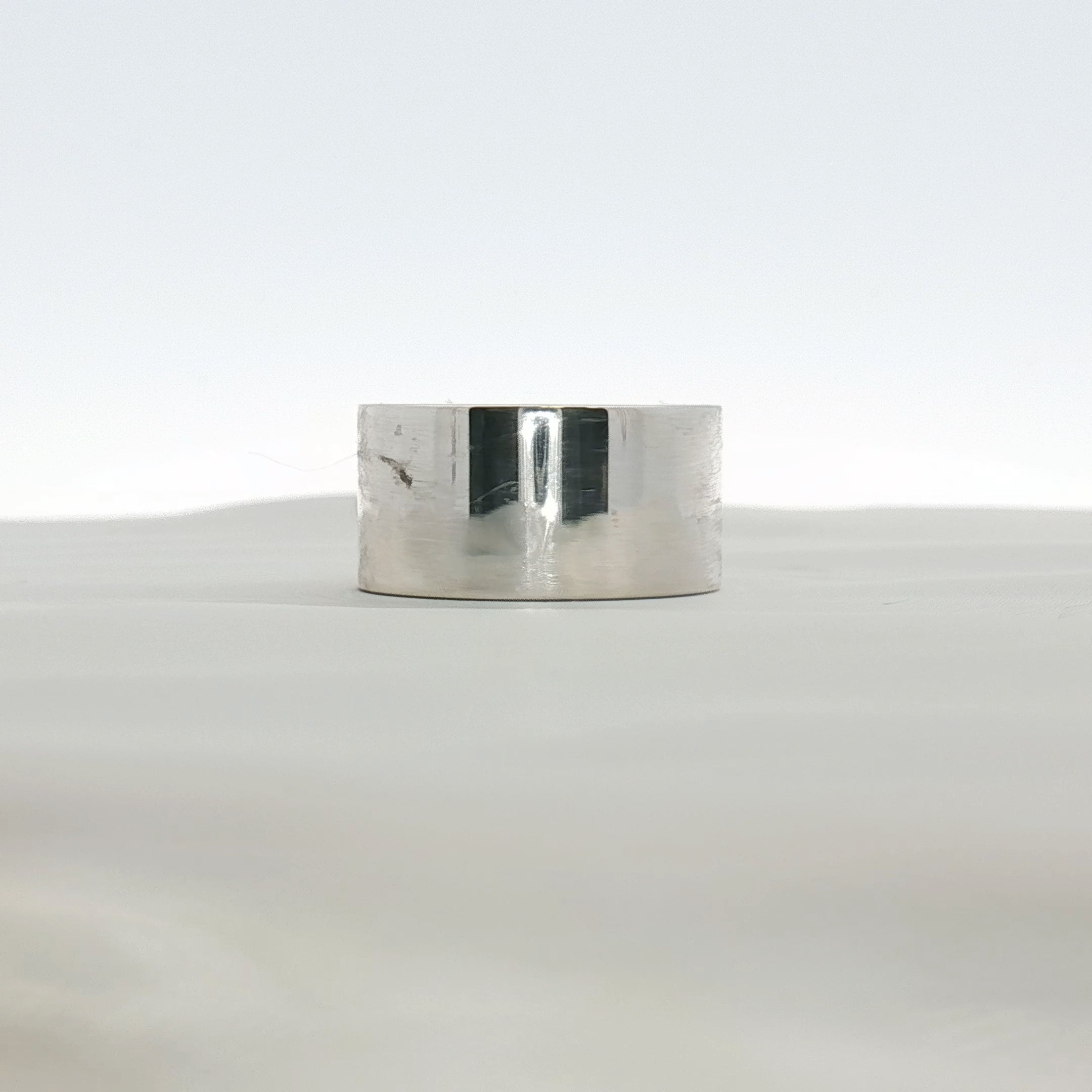 Gold & Beyond Tiffany & Co. T wide gold ring showcasing a sleek, polished jewelry design with a smooth finish.