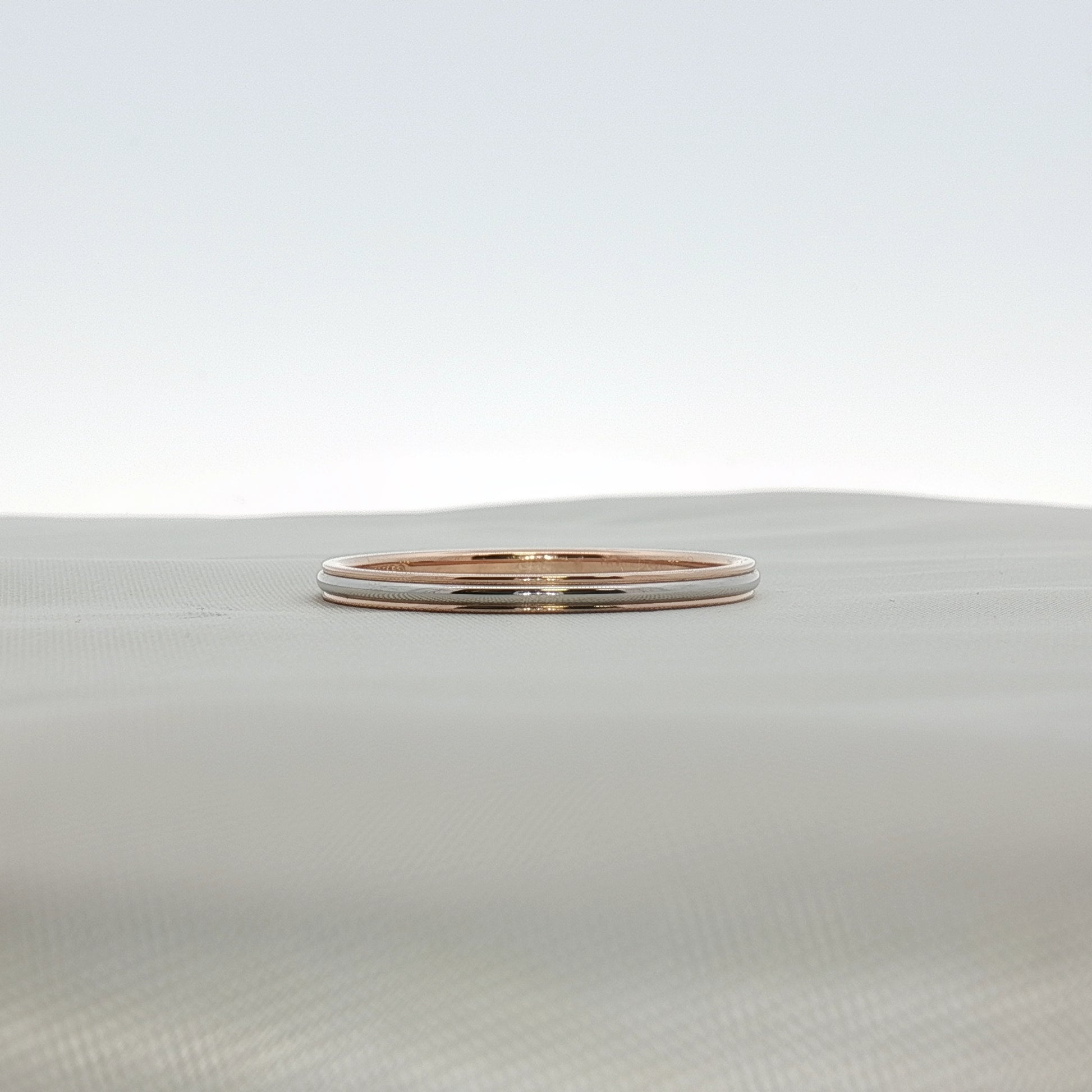 Two-tone Tiffany & Co. wedding band ring crafted by Gold & Beyond, featuring intertwined gold and silver design.