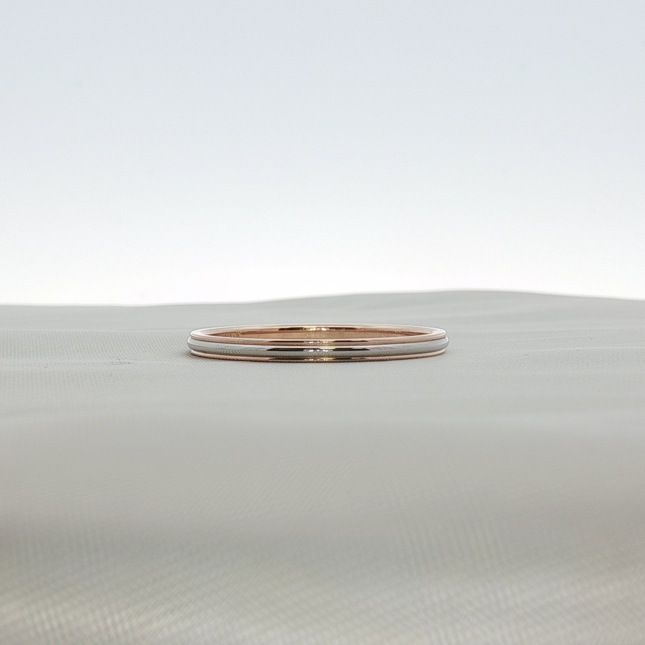 Two-tone Tiffany & Co. wedding band ring featuring gold and silver elements, crafted by Gold & Beyond.