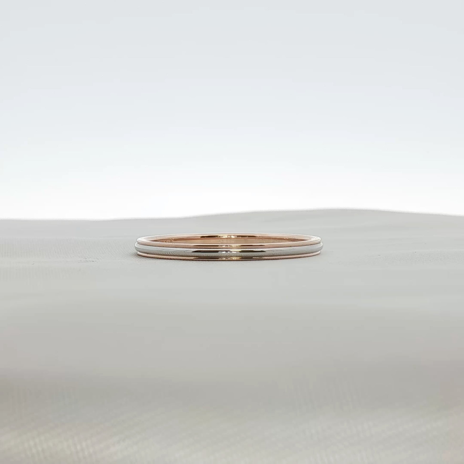 Two-tone Tiffany & Co. wedding band ring in gold and silver with a sleek, polished design, crafted by Gold & Beyond.