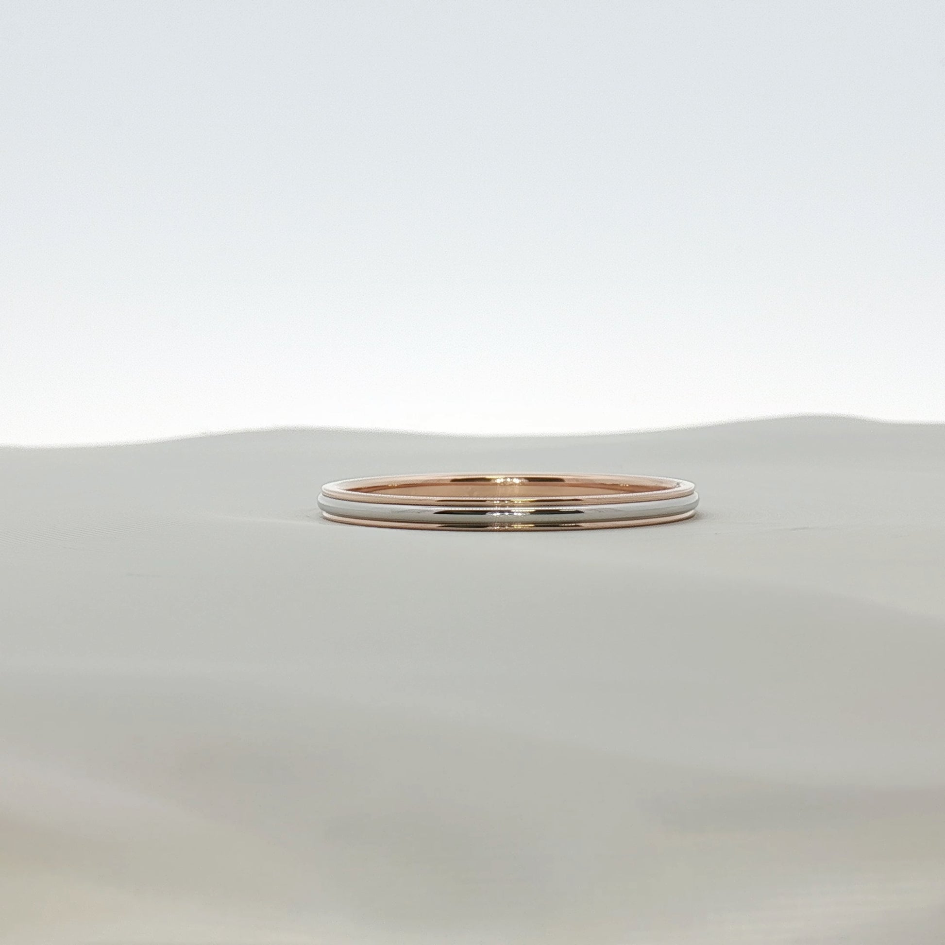 Two-tone Tiffany & Co. wedding band ring with gold and silver finishes, showcasing elegant jewelry design.