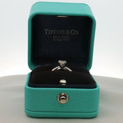 Gold & Beyond Tiffany & Co. princess-cut diamond solitaire ring with a sleek platinum band, showcasing a sparkling center diamond.