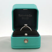 Platinum solitaire engagement ring by Gold & Beyond featuring a central diamond set in a sleek Tiffany & Co. style jewelry design.
