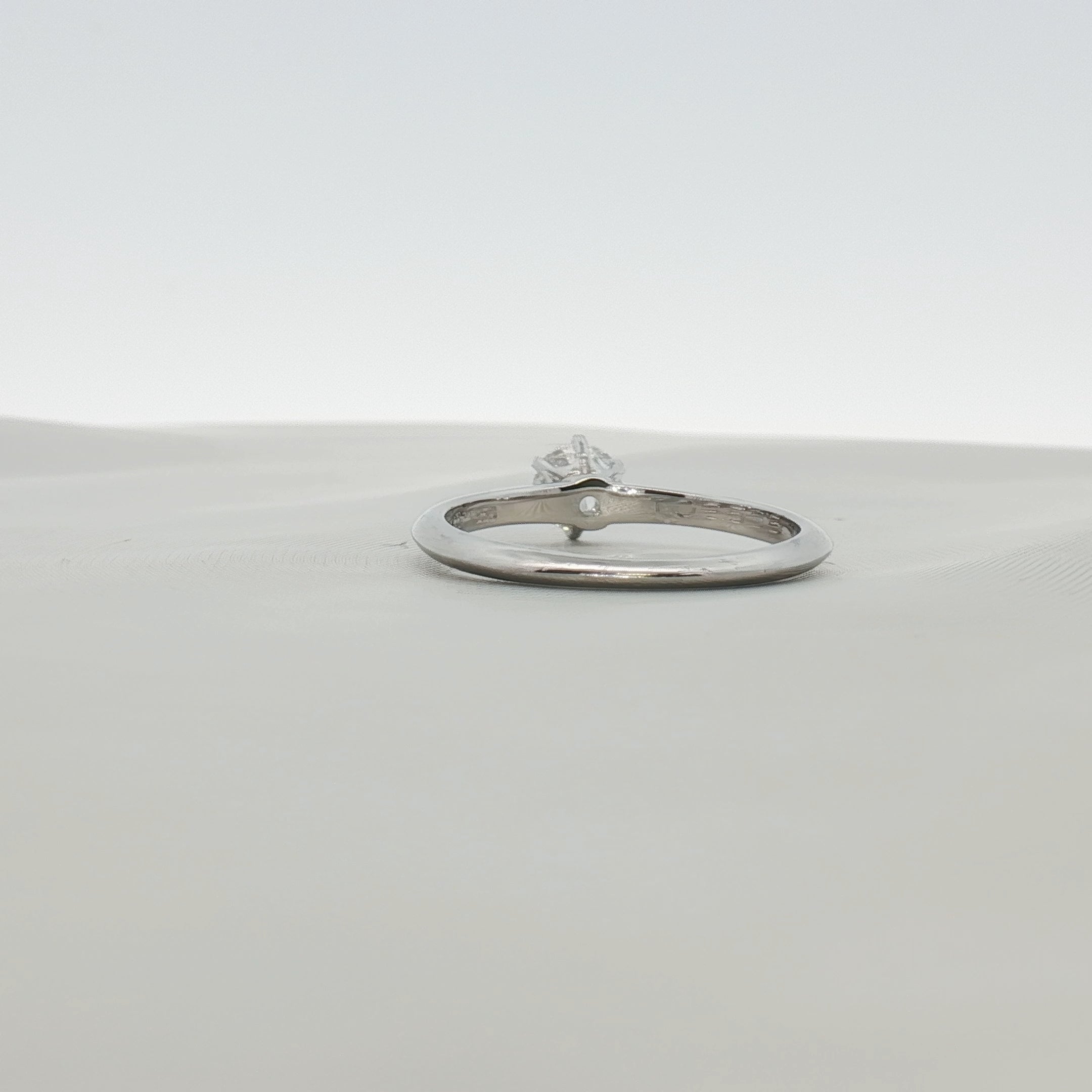 Platinum solitaire engagement ring by Gold & Beyond featuring a single sparkling diamond set in a sleek band.
