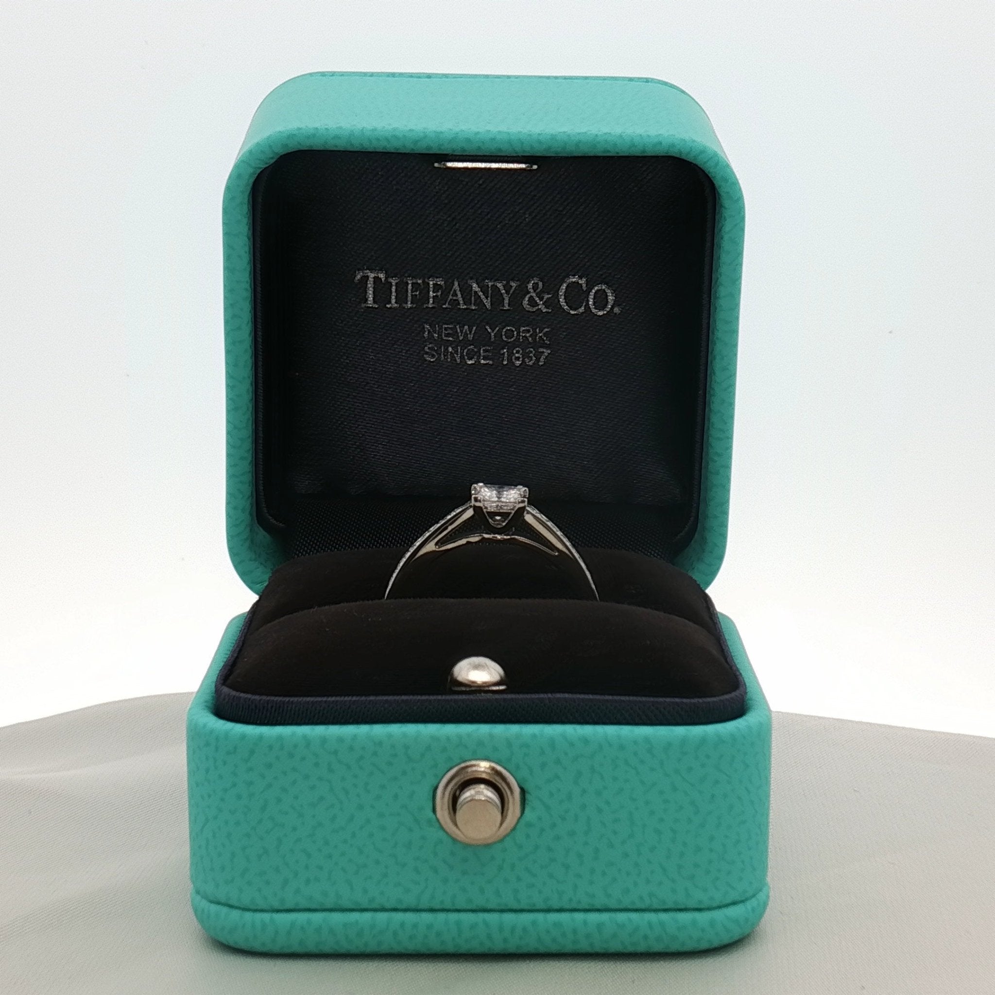 Gold & Beyond Tiffany & Co. Grace Princess Diamond Ring, elegant jewelry featuring a sparkling diamond centerpiece on a gold band.