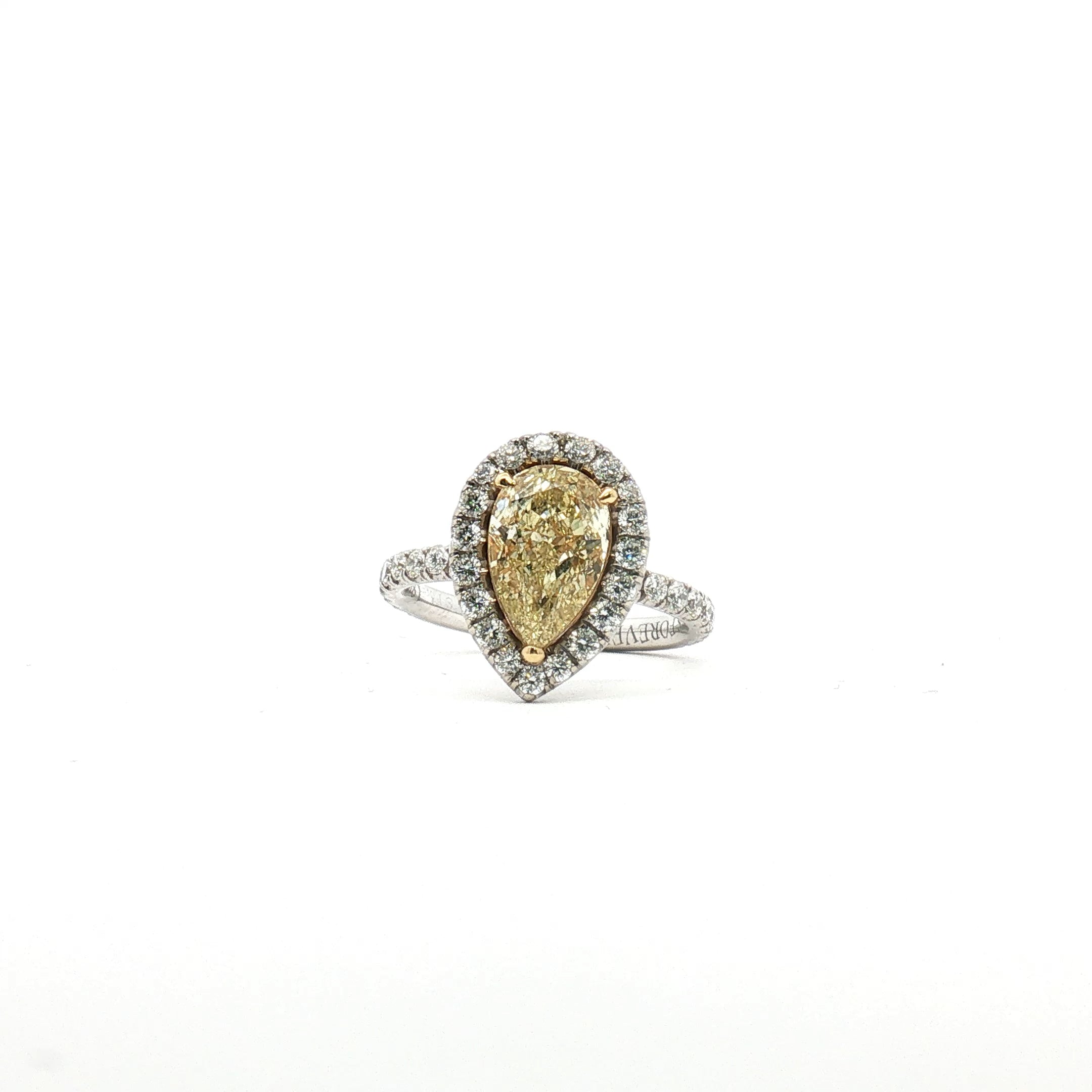 18K white gold yellow diamond pear halo ring with intricate detailing, showcasing sparkling gemstones in a luxurious jewelry design.