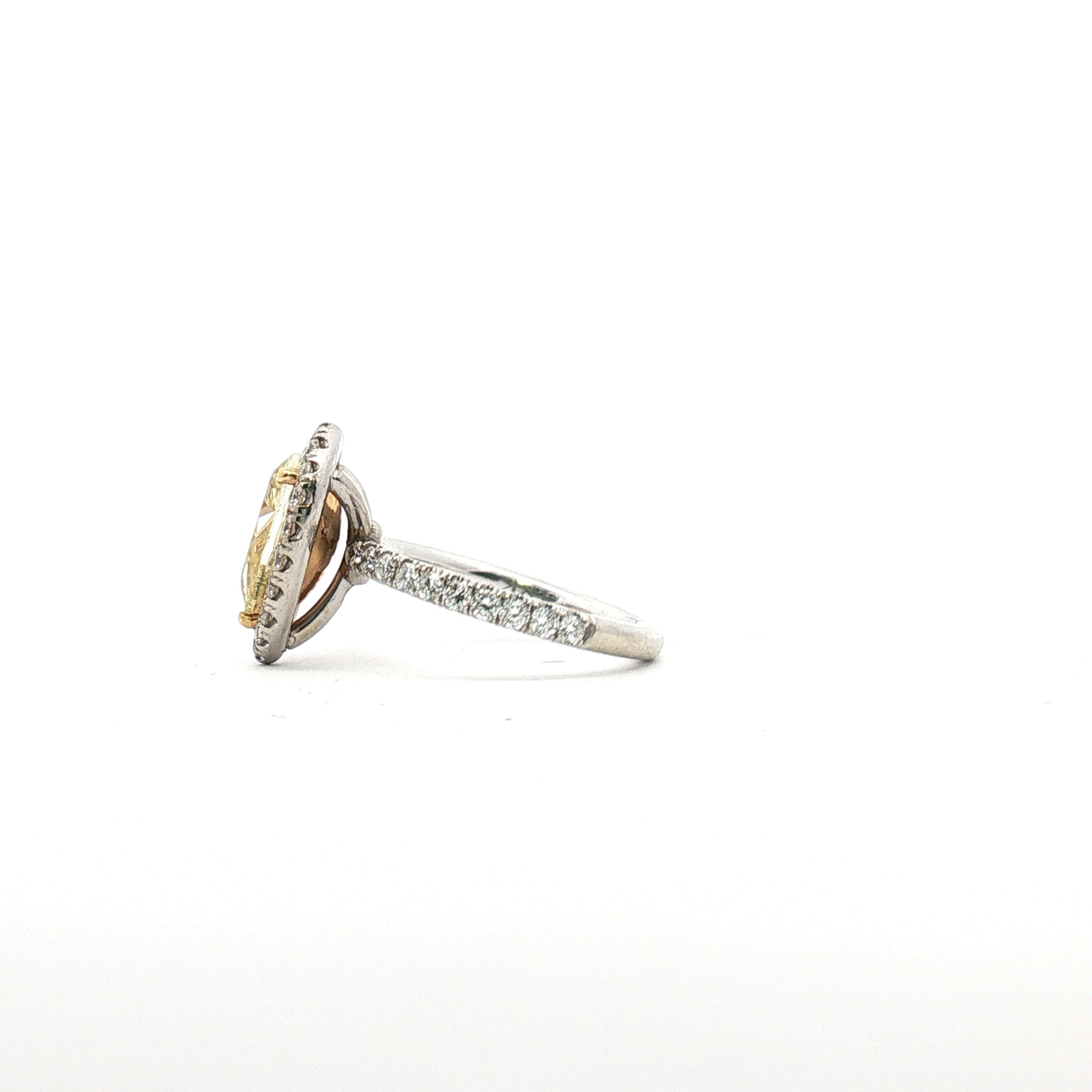 18K white gold yellow diamond pear halo ring with sparkling diamonds, showcasing elegant jewelry design.