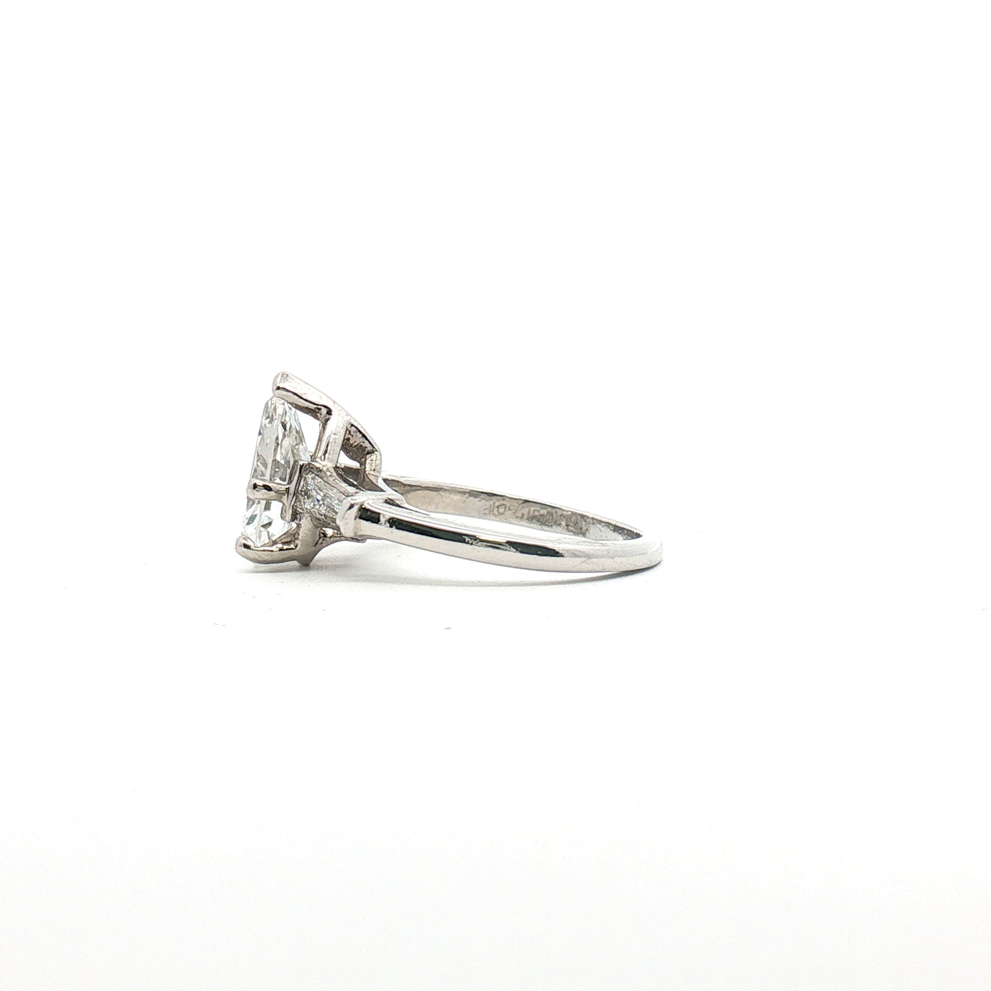 Platinum Pear Diamond Three-Stone Ring by Gold & Beyond showcasing three sparkling pear-shaped diamonds set in a sleek platinum band.