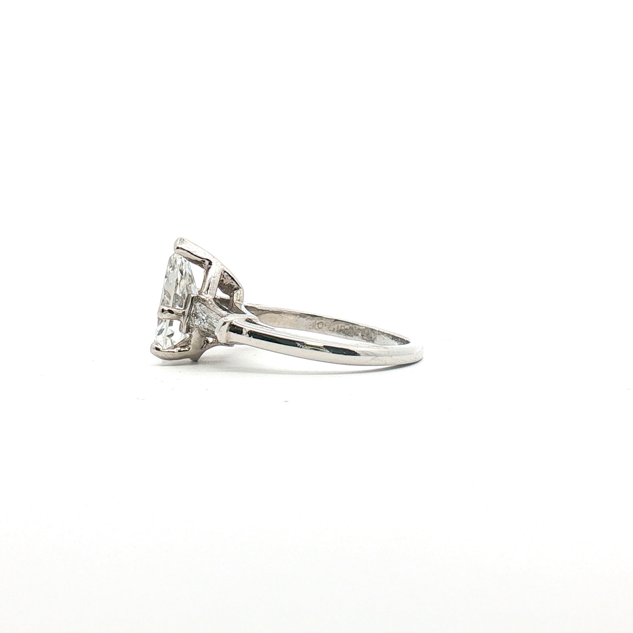 Platinum Pear Diamond Three-Stone Ring by Gold & Beyond showcasing three sparkling pear-shaped diamonds set in a sleek platinum band.