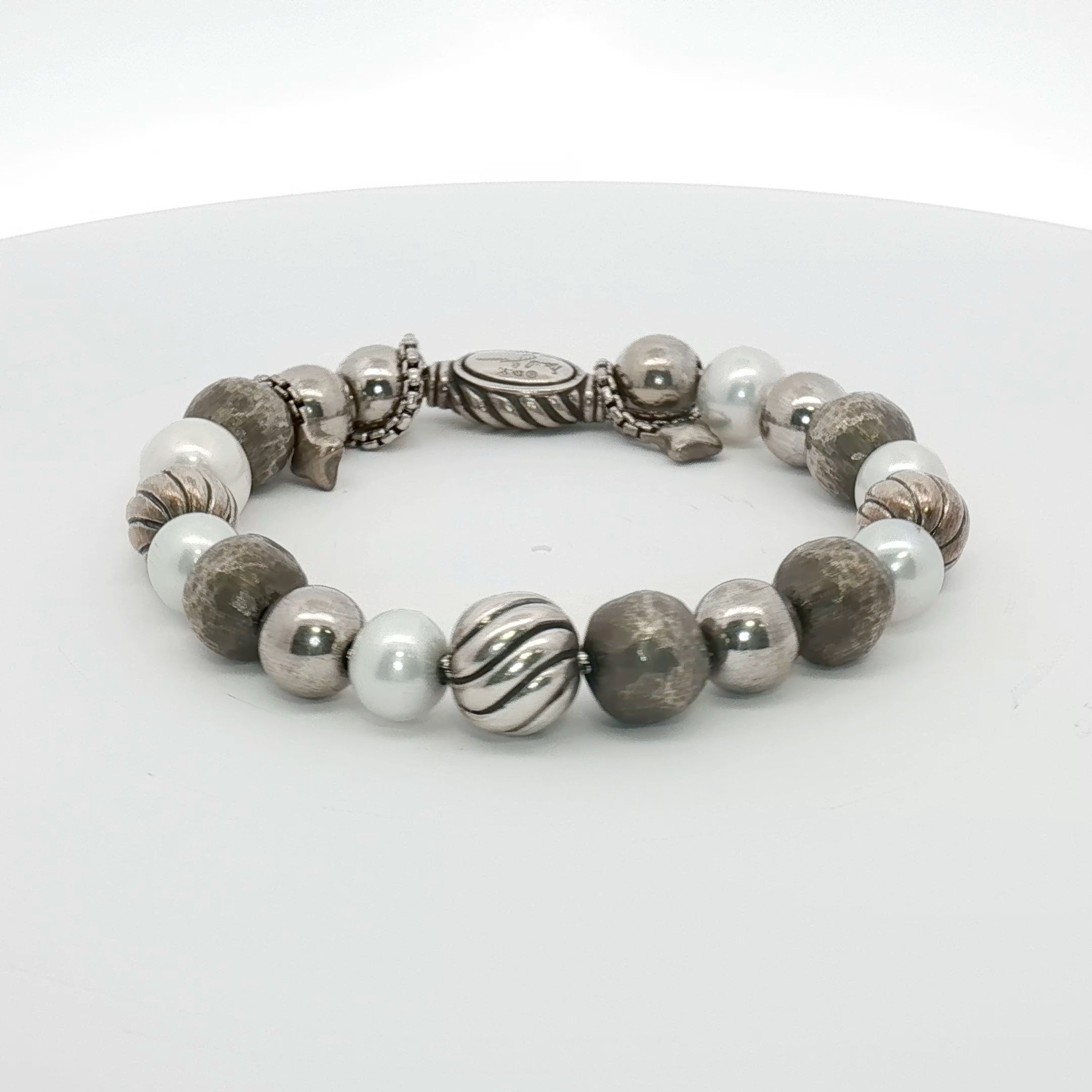 Sterling silver beaded bracelet by David Yurman featuring a sleek, polished design, displayed on a neutral background.