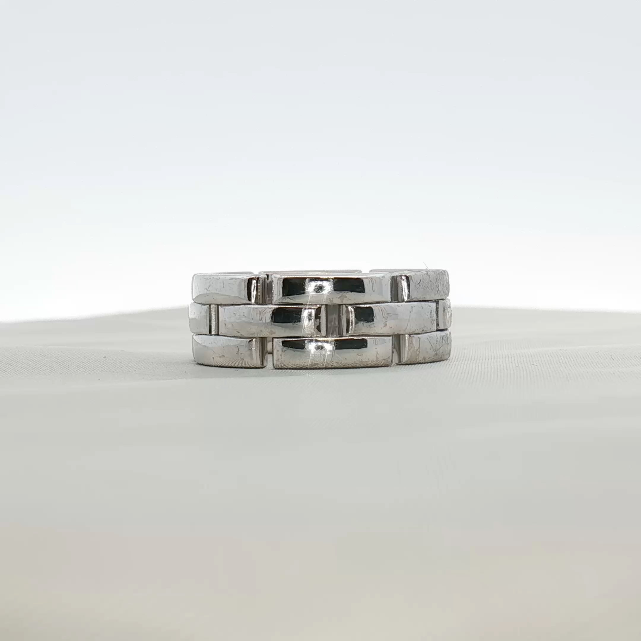 Cartier Maillon Band Ring in gold jewelry, featuring linked chain design, worn on a finger with a smooth finish and elegant style.