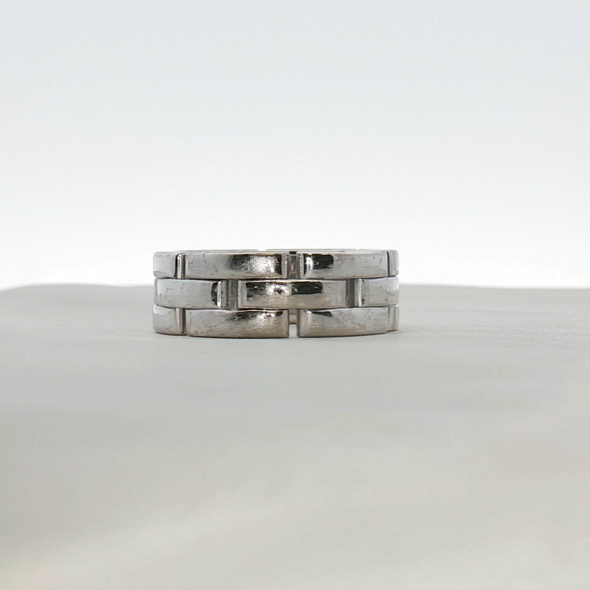 Cartier Maillon Band Ring featuring gold links, showcasing a luxurious jewelry design with intricate craftsmanship.