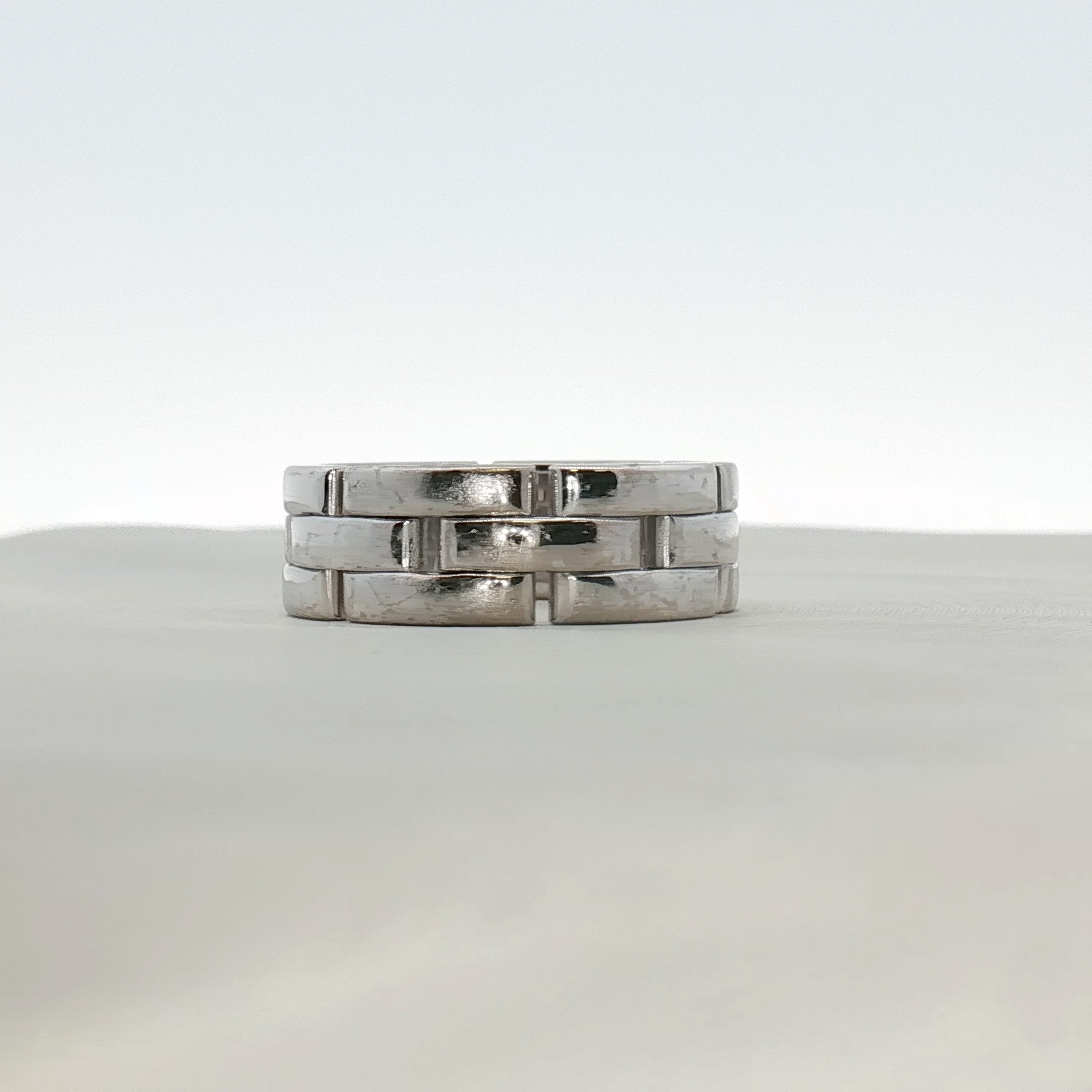 Cartier Maillon Band Ring featuring gold links, showcasing a luxurious jewelry design with intricate craftsmanship.