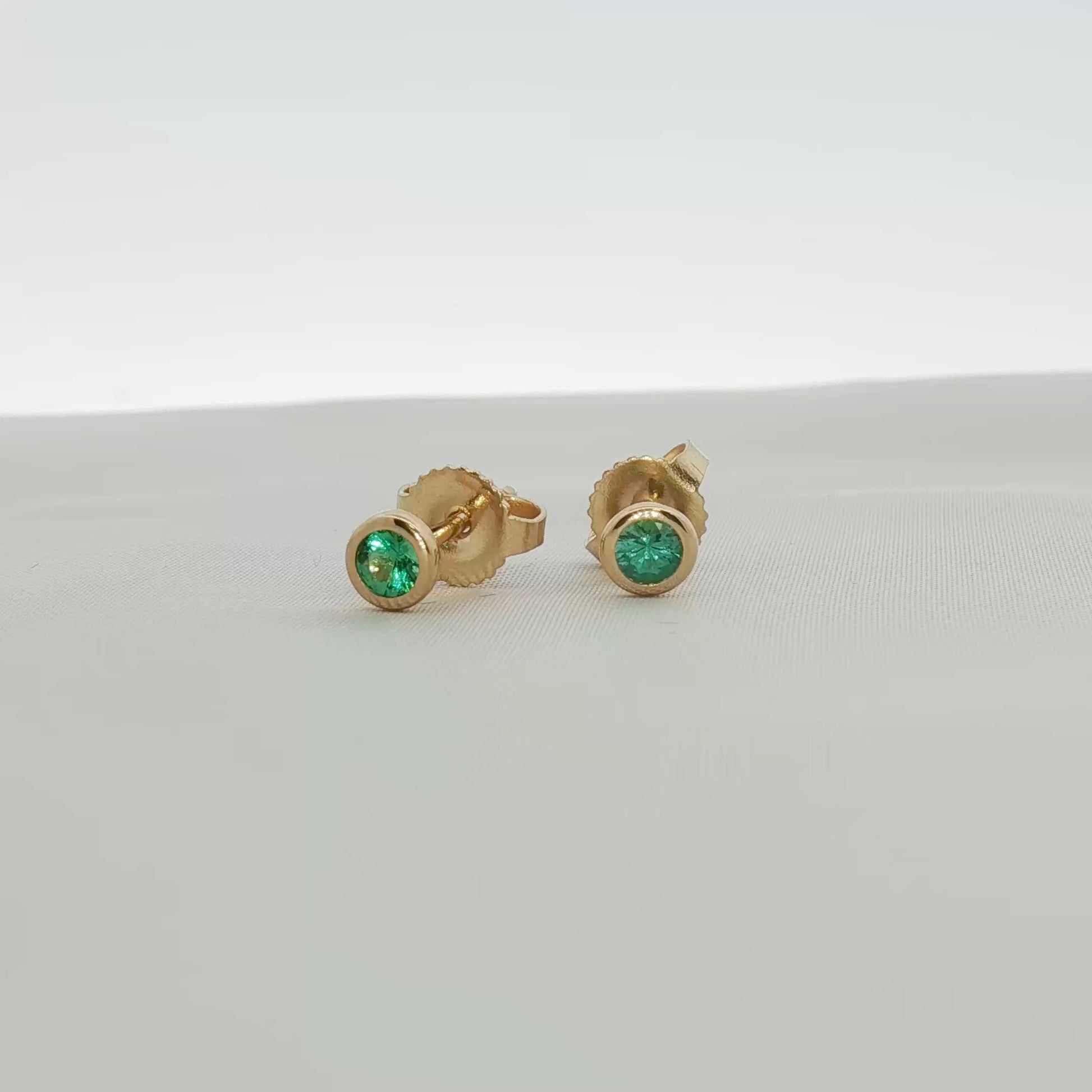 18K yellow gold Tiffany & Co. emerald stud earrings with vibrant green gemstones, jewelry piece by Gold & Beyond.
