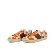 Gold & Beyond Gucci Strawberry Sneakers, stylish shoes with strawberry designs, featuring white laces and colorful accents.
