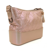 Chanel Gabrielle handbag with a stylish design and gold accents, elegantly displayed against a neutral background.