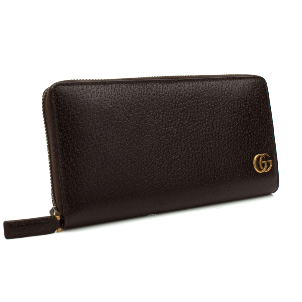 Gucci GG Marmont wallet in black leather with gold hardware and quilted design displayed on a white background.