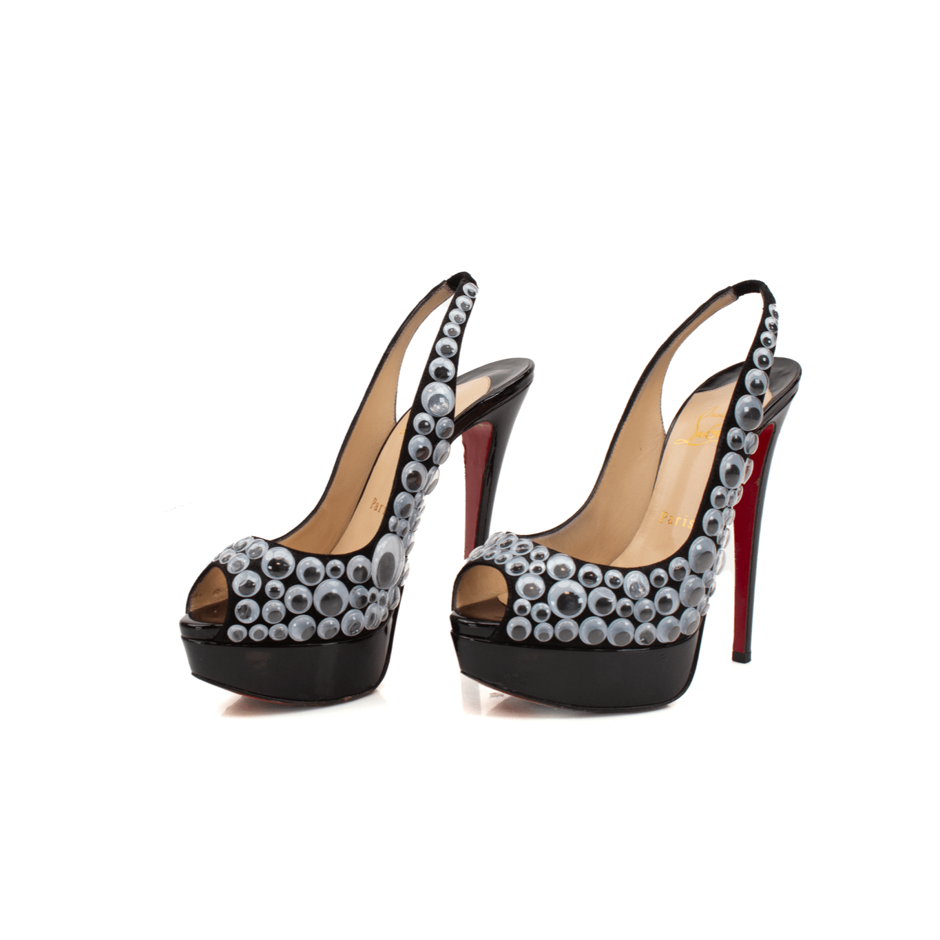 Christian Louboutin Deja Vu 150 platform heels with gold accents and signature red sole, photographed from a side angle.