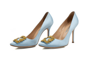 Manolo Blahnik crystal satin heels featuring elegant design, pointed toes, and sparkling embellishments for a sophisticated look.