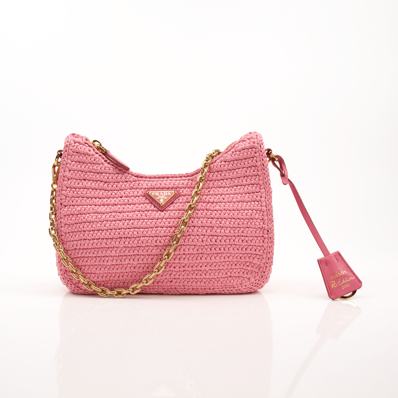 Pink Prada 2005 Re-Edition crochet handbag by Gold & Beyond, featuring a stylish, textured design with gold-tone accents.