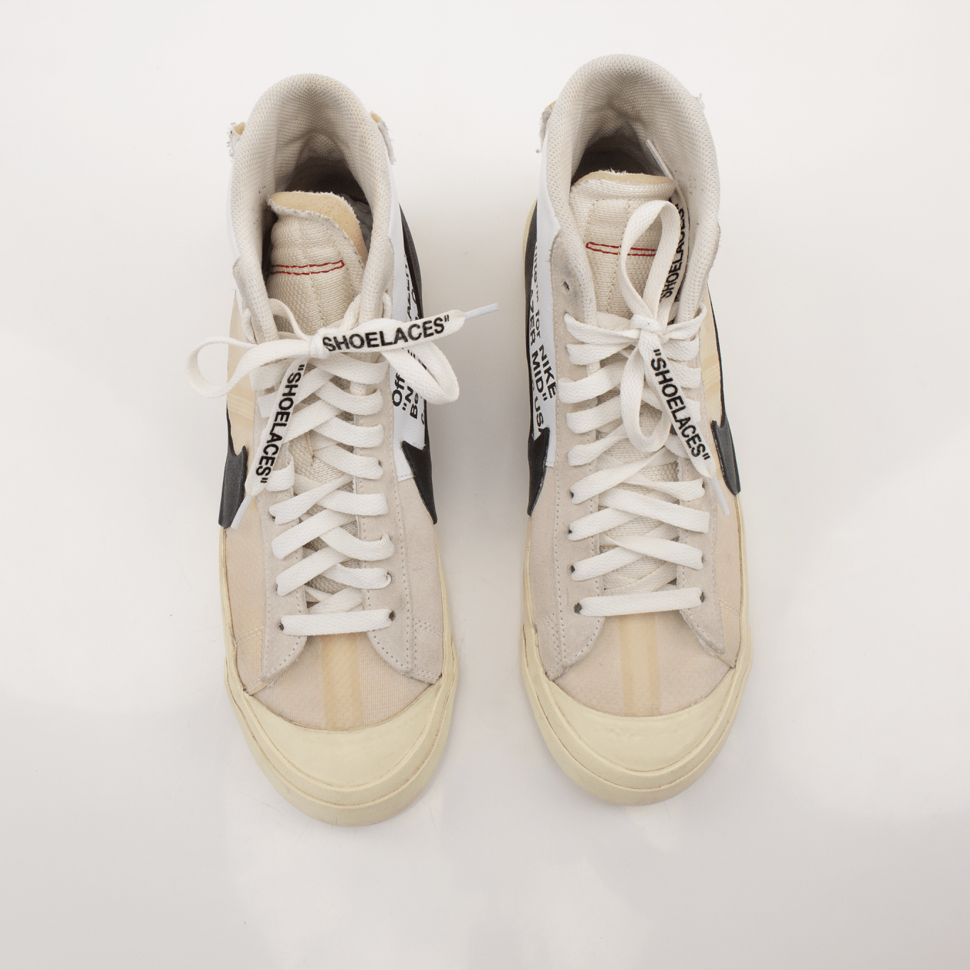 Nike x Off-White Blazer shoes featuring white leather upper, signature deconstructed design, and distinctive orange accents.