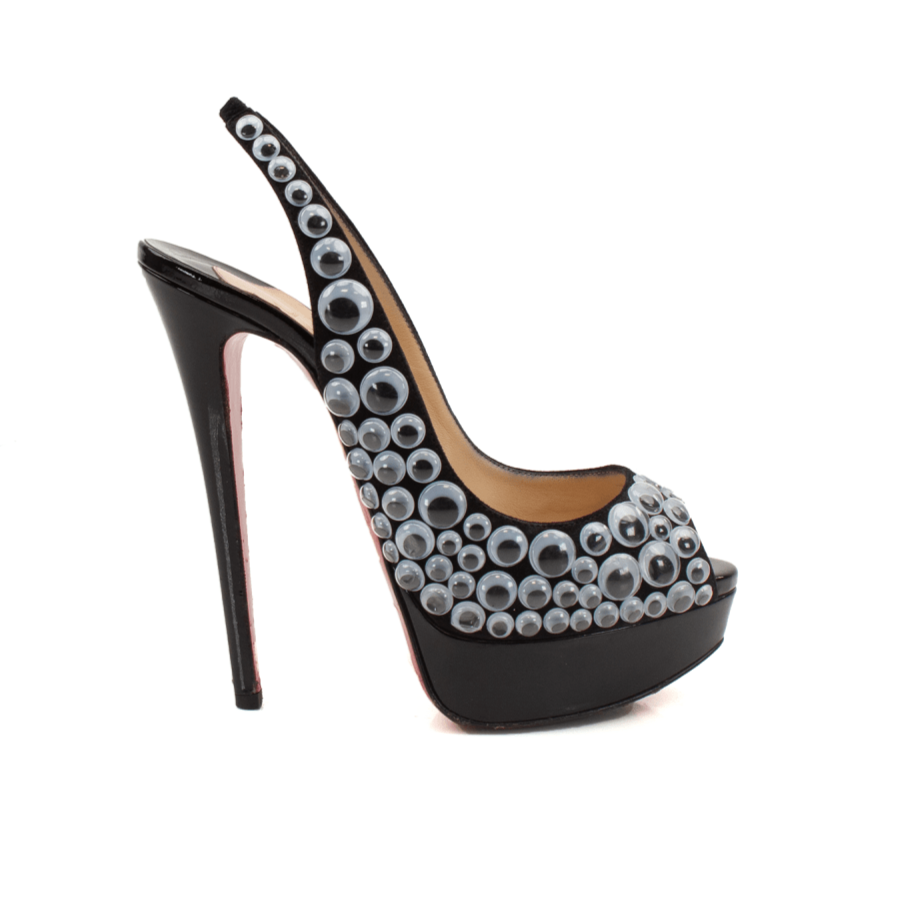 Christian Louboutin Deja Vu 150 platform heels in gold with signature red soles, showcased from a side view.