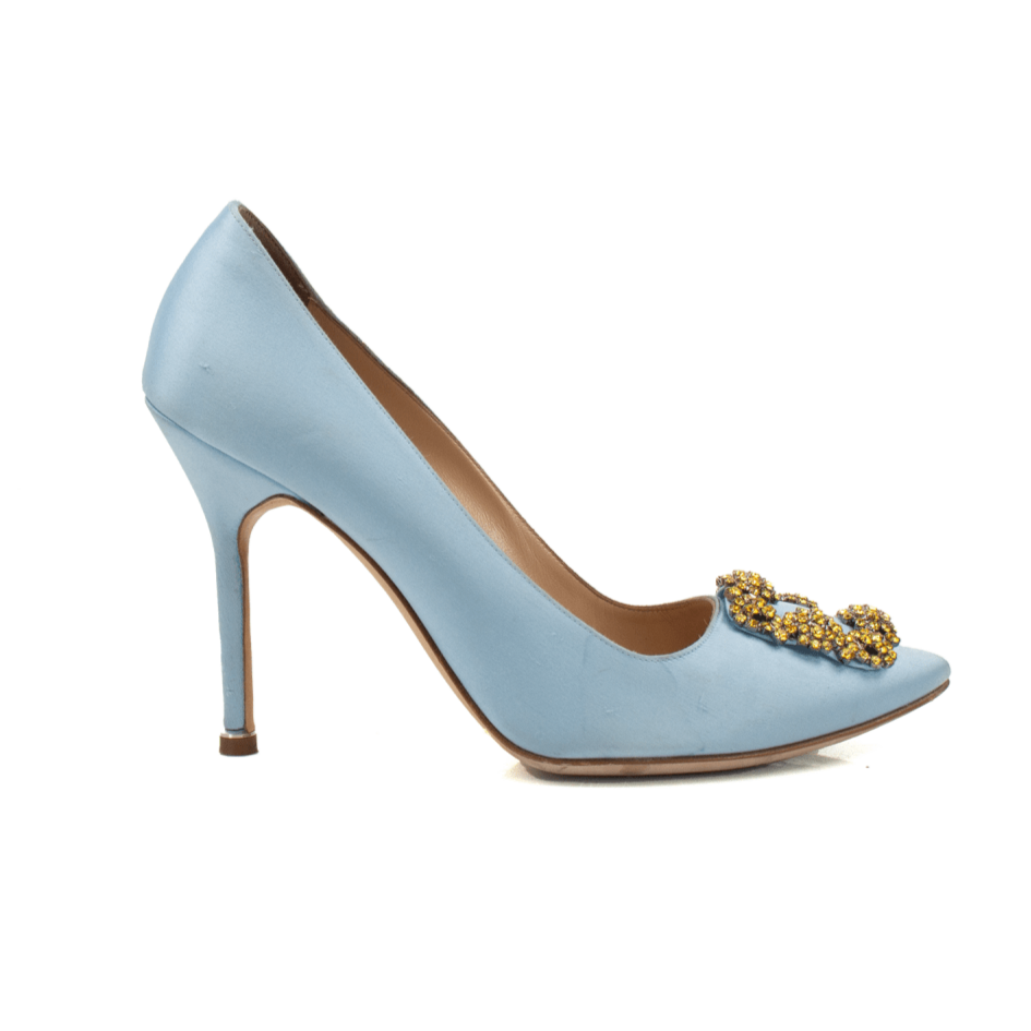 Manolo Blahnik crystal satin heels in elegant gold, featuring a pointed toe and delicate ankle strap.