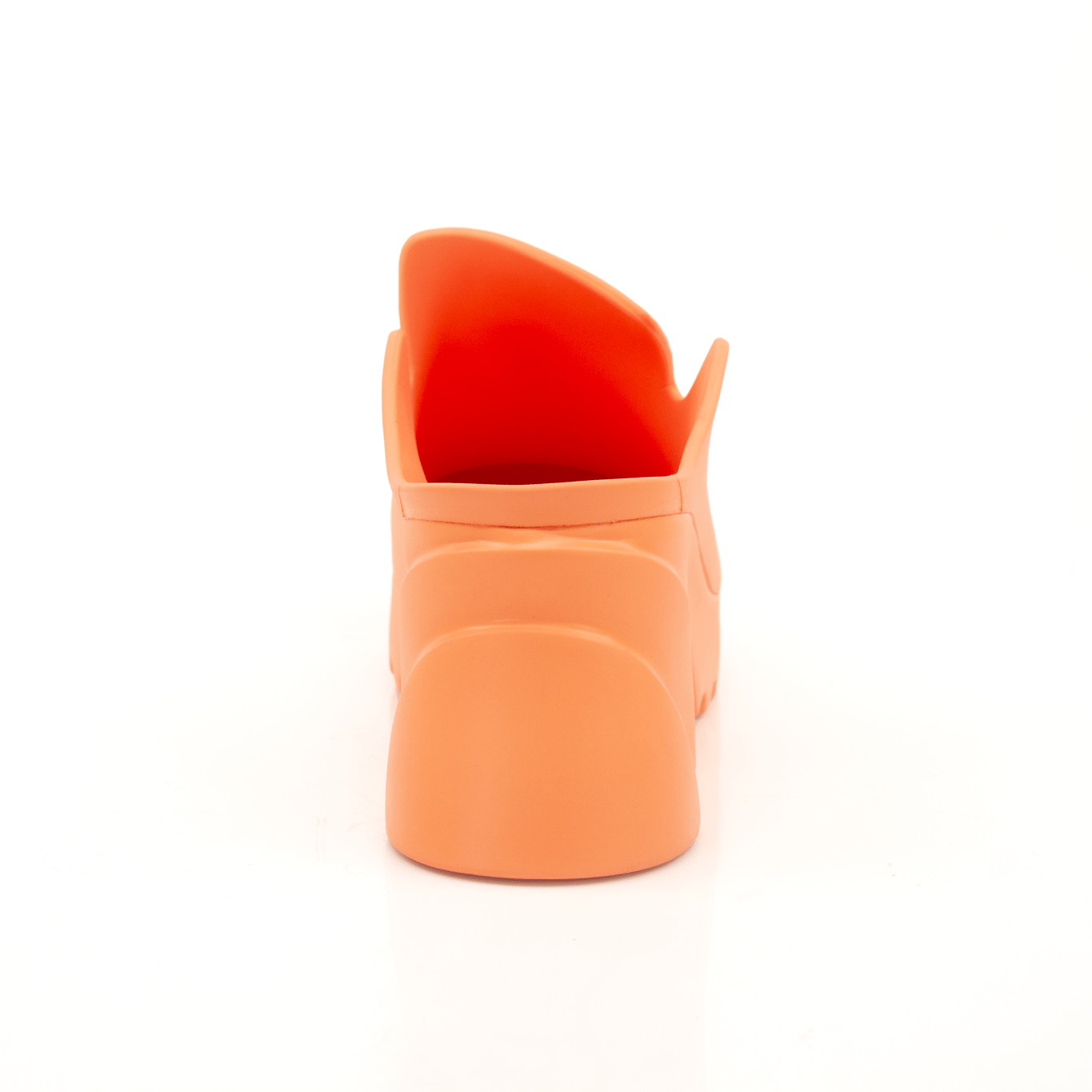 Orange rubber clog shoes by Bottega Veneta featuring a slip-on design and textured sole, displayed on a neutral background.