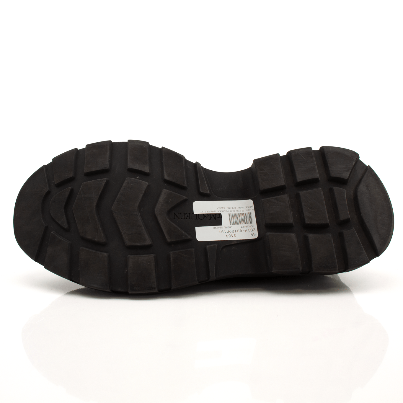 Gold & Beyond Alexander McQueen oversized sneakers with chunky white soles and black leather uppers, stylish and modern footwear.