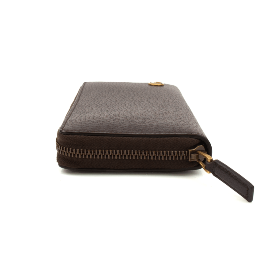 Gucci GG Marmont wallet in black leather with gold hardware, showcasing the iconic GG logo and quilted design.