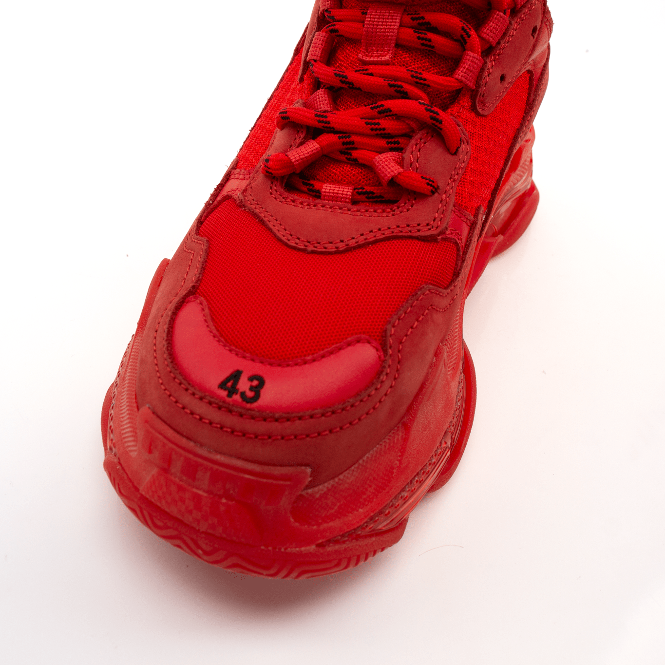 Gold & Beyond Balenciaga Triple S sneakers, stylish chunky shoes with a multi-layered sole and designer branding.