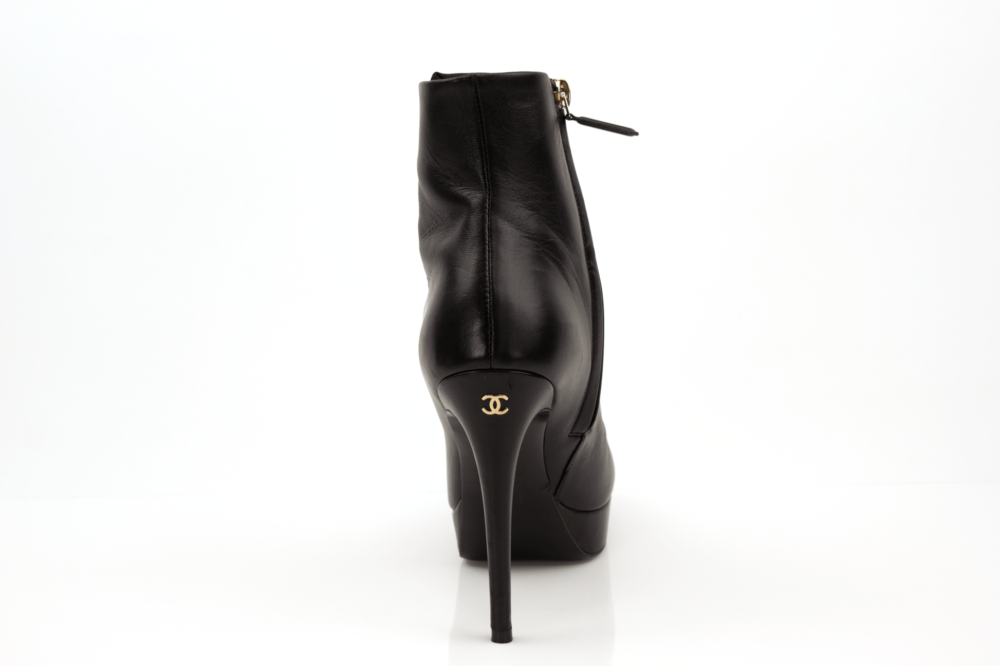 Gold & Beyond Chanel patent leather heels, stylish women's shoes with sleek, shiny finish and elegant design.