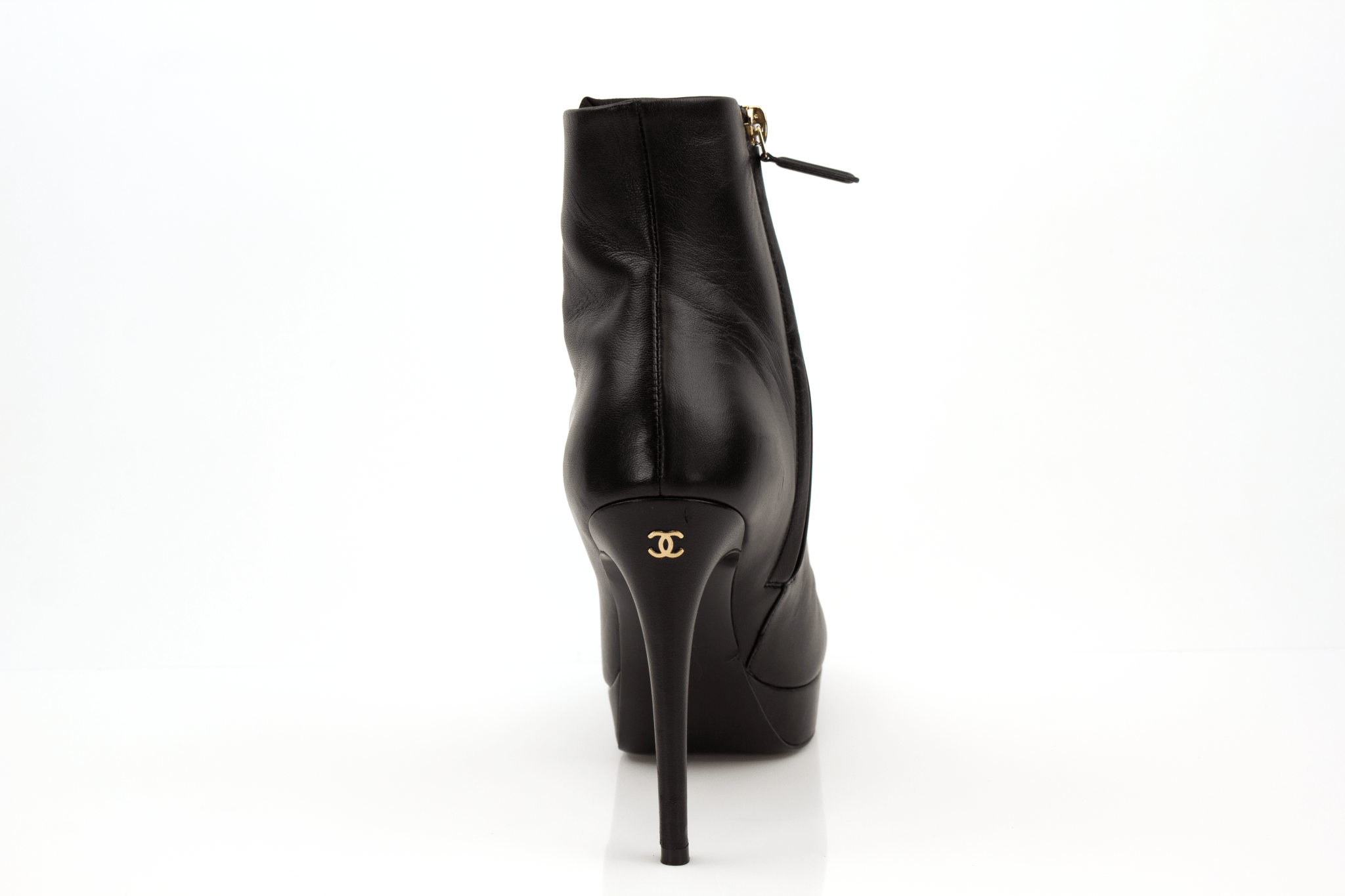 Gold & Beyond Chanel patent leather heels, stylish women's shoes with sleek, shiny finish and elegant design.