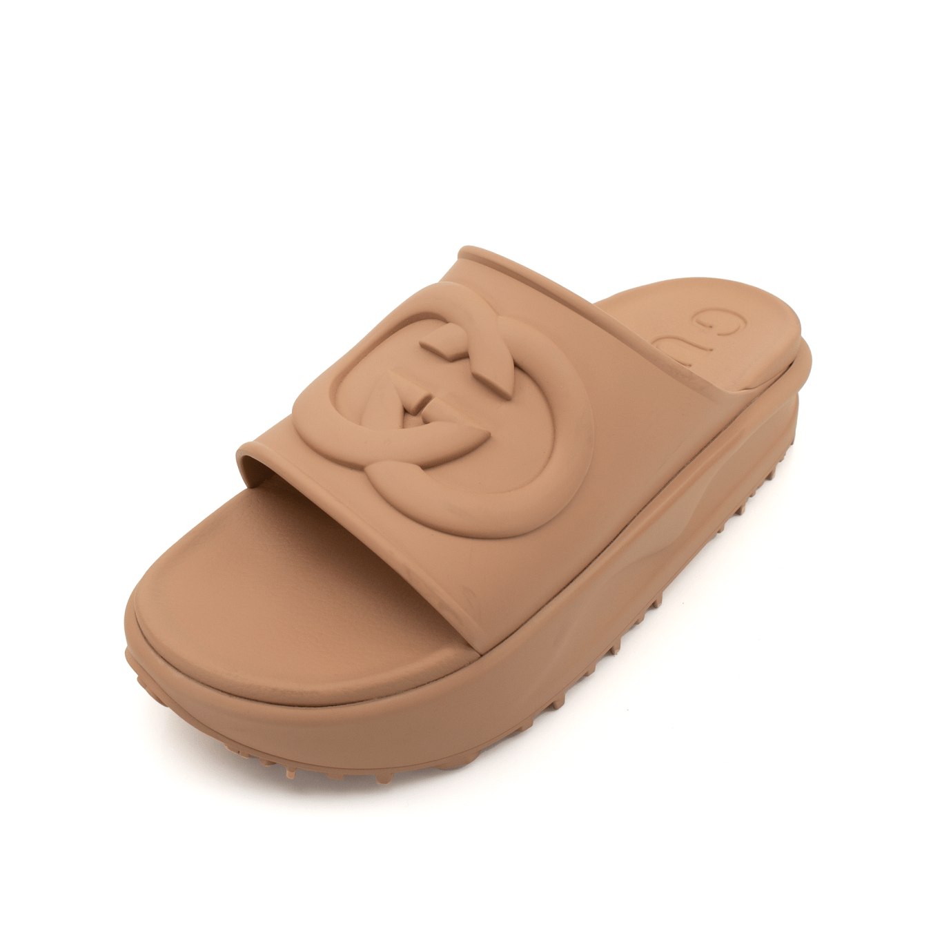 Gold & Beyond Gucci platform slides showing beige straps and chunky rubber soles, stylish open-toe shoes for casual wear.