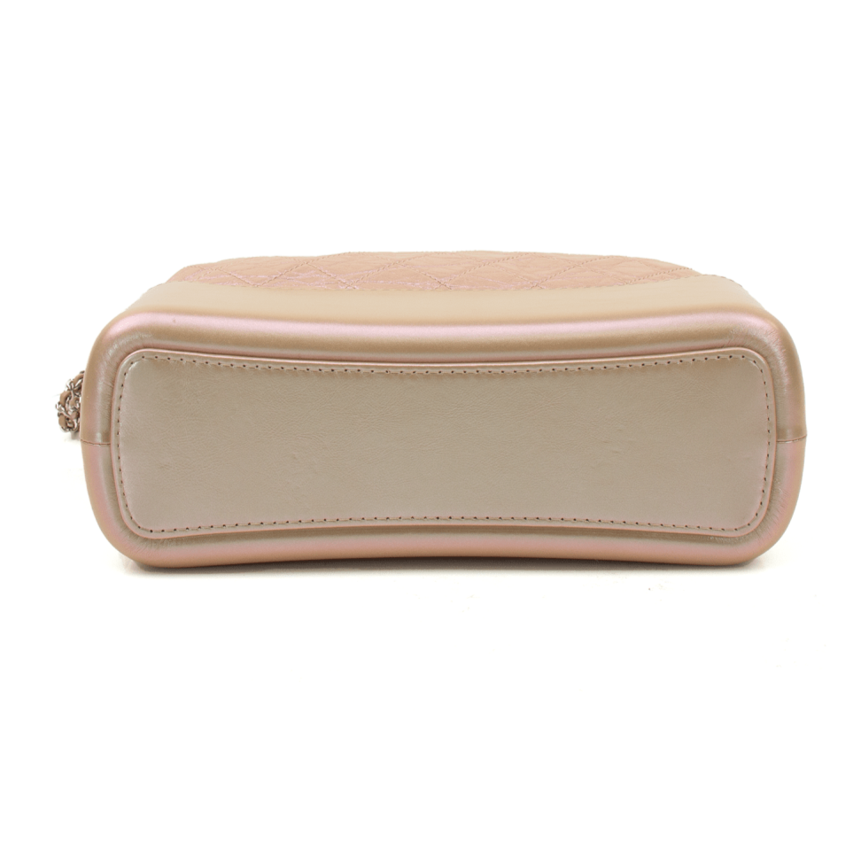 Chanel Gabrielle handbag in a stylish design with gold accents and a spacious interior, showcased against a neutral background.