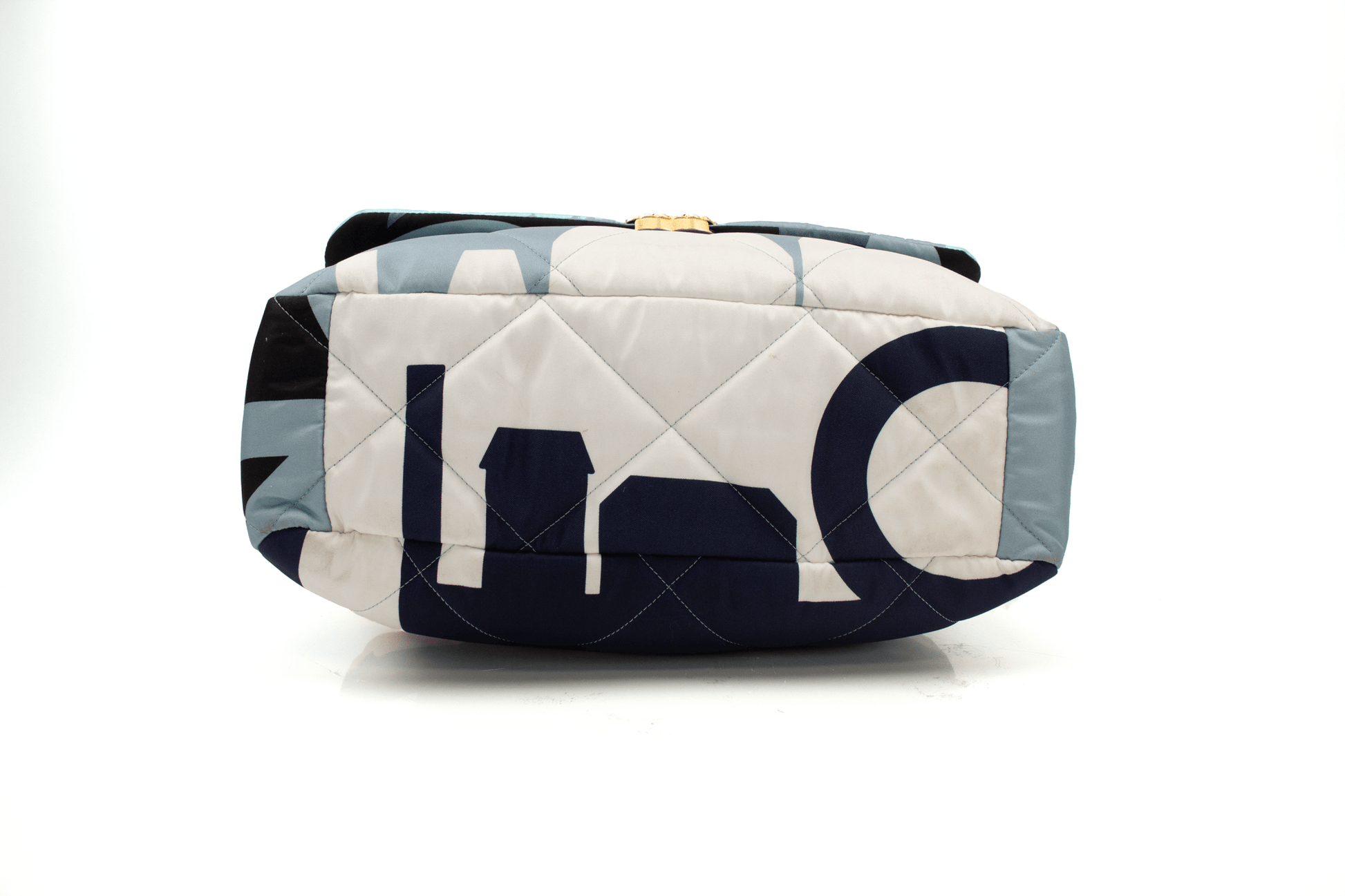 Chanel 19 Silk Flap handbag in elegant silk fabric with signature quilting and gold-tone hardware, showcased on a soft surface.