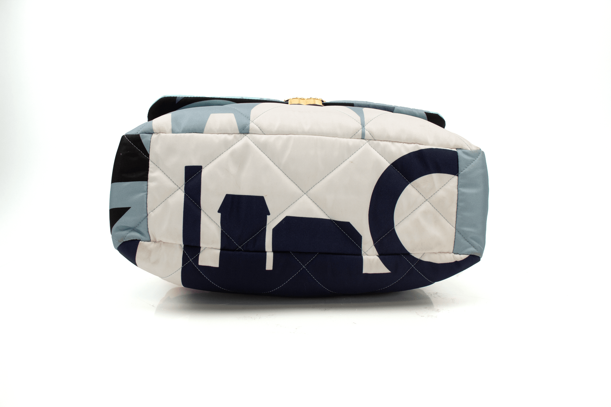 Chanel 19 Silk Flap handbag in elegant silk fabric with signature quilting and gold-tone hardware, showcased on a soft surface.