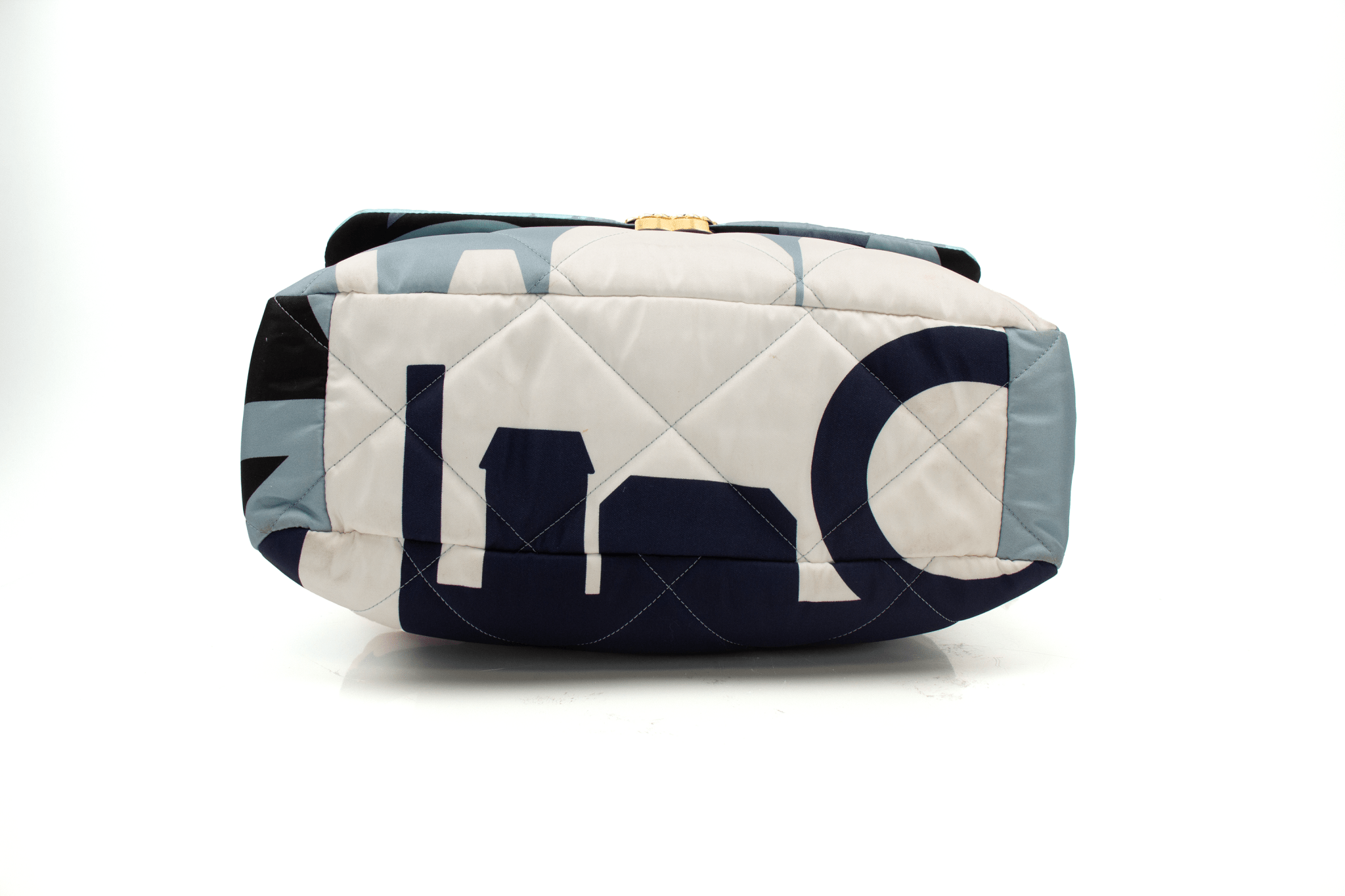 Chanel 19 Silk Flap handbag in elegant silk fabric with signature quilting and gold-tone hardware, showcased on a soft surface.