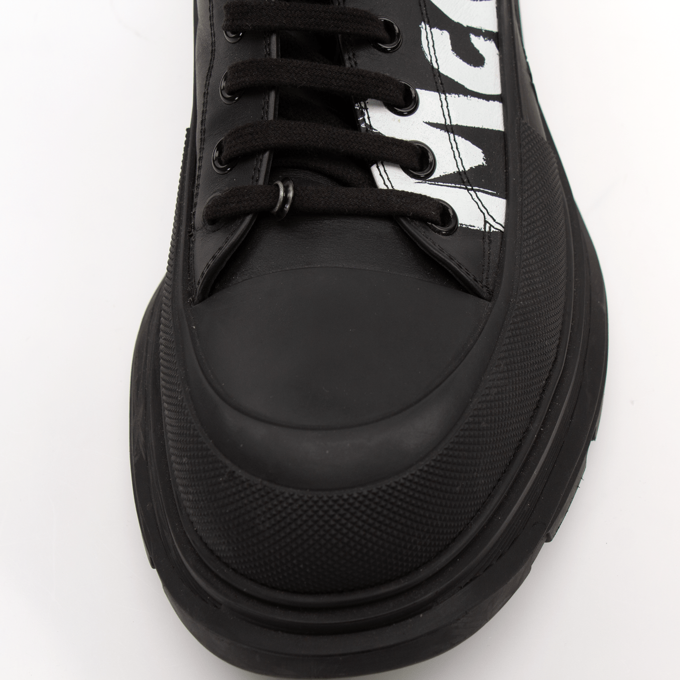 Gold & Beyond Alexander McQueen oversized sneakers, stylish white shoes with chunky design and branded details.