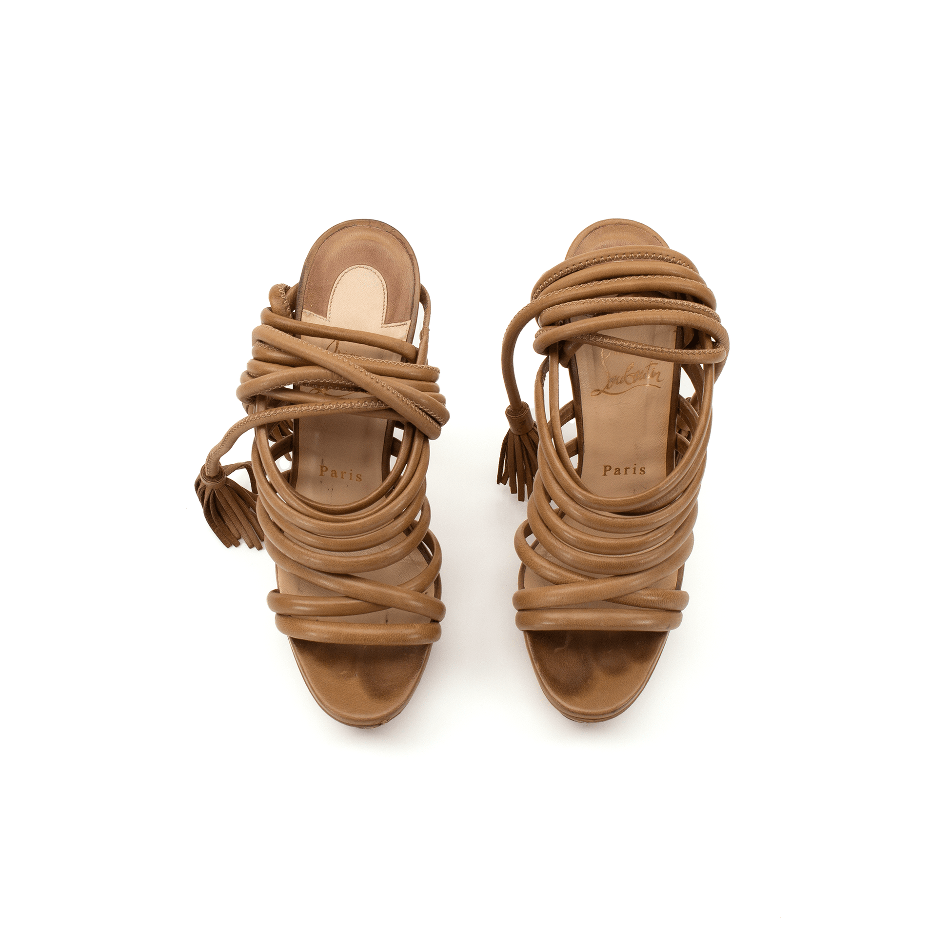 Gold & Beyond Christian Louboutin tassel platform heels with high heels and elegant tassel details on a stylish footwear display.