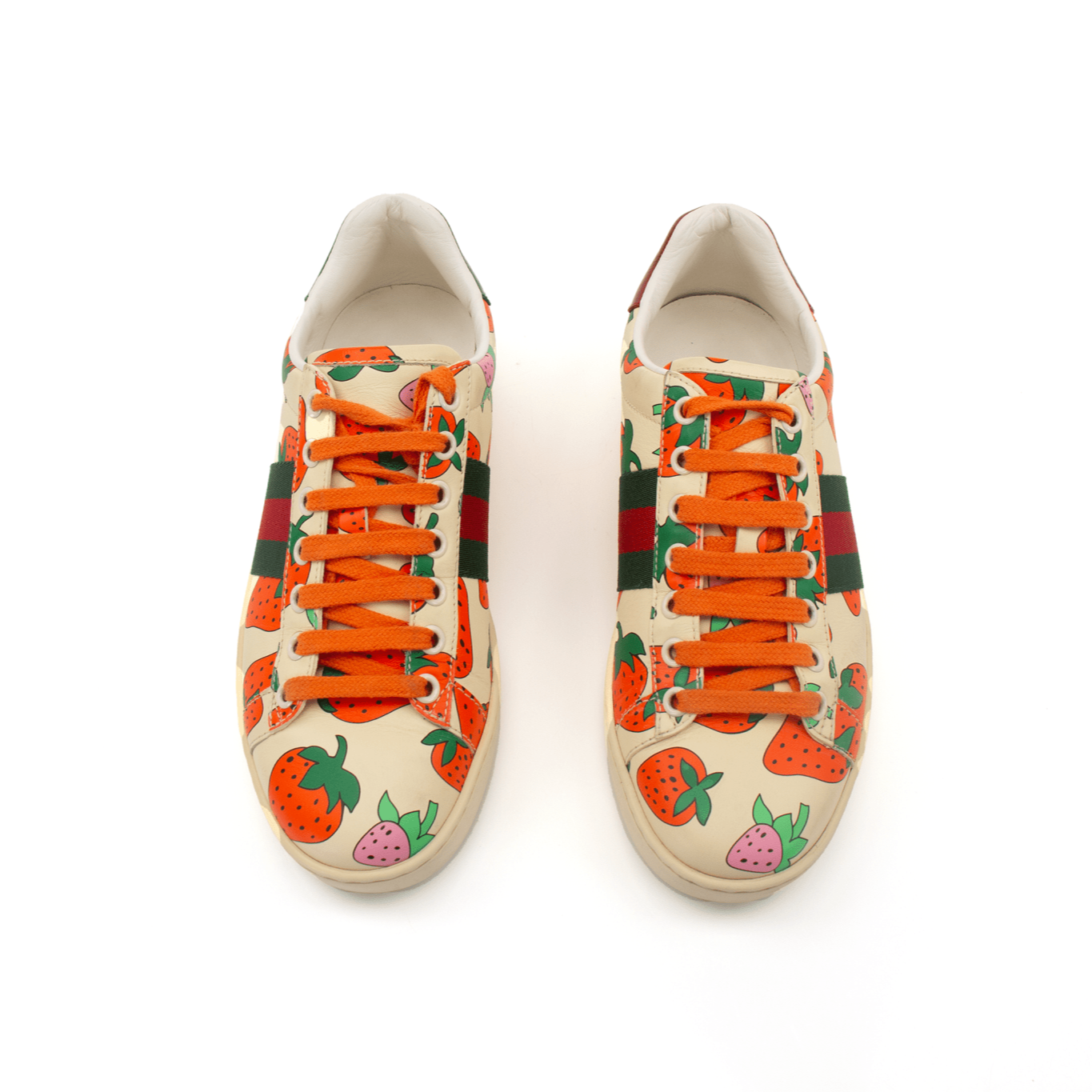 Gold & Beyond Gucci Strawberry Sneakers showing colorful canvas shoes with strawberry designs and white rubber soles.